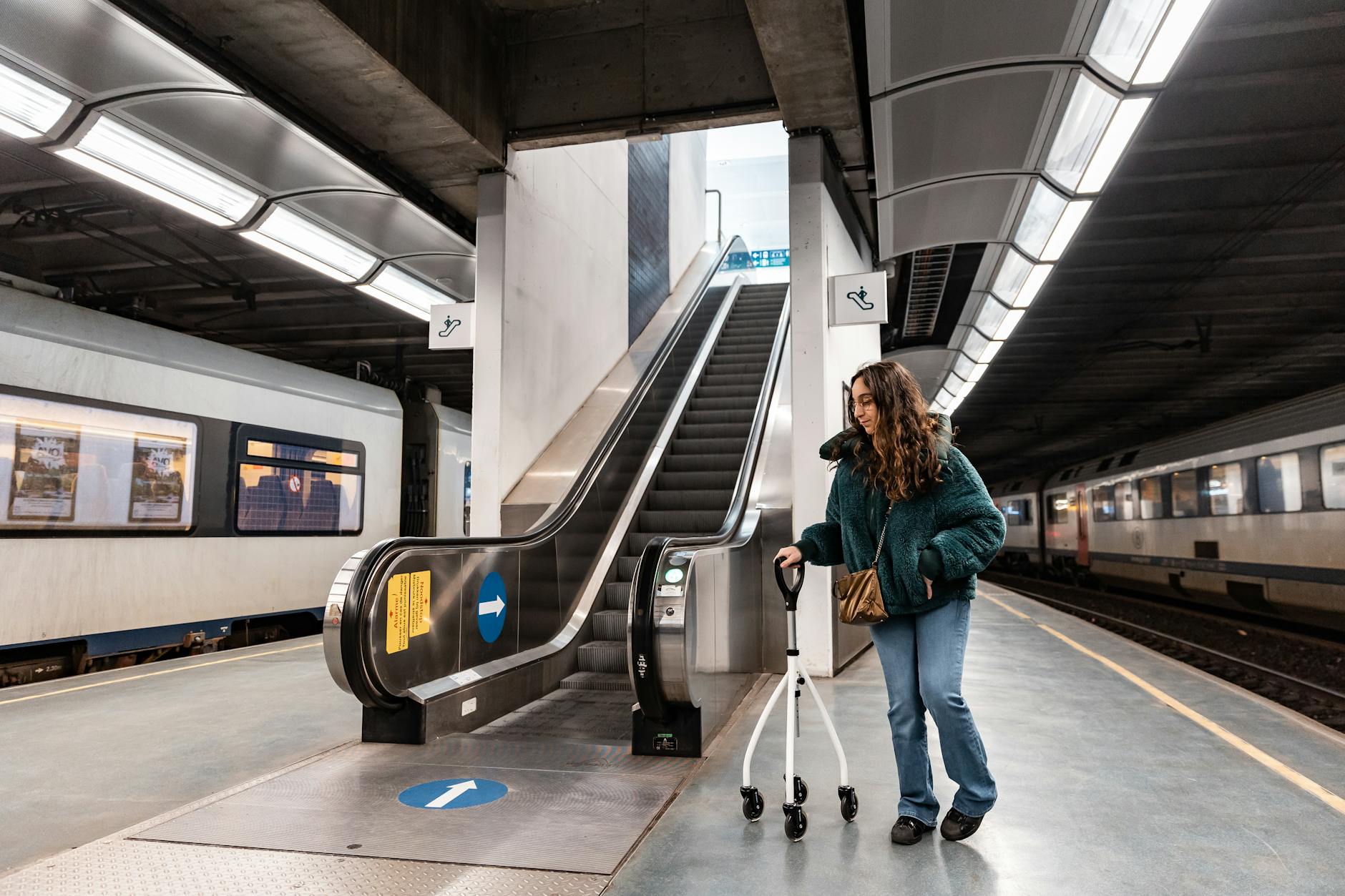 Traveler with a mobility aid at a train station for access planning.