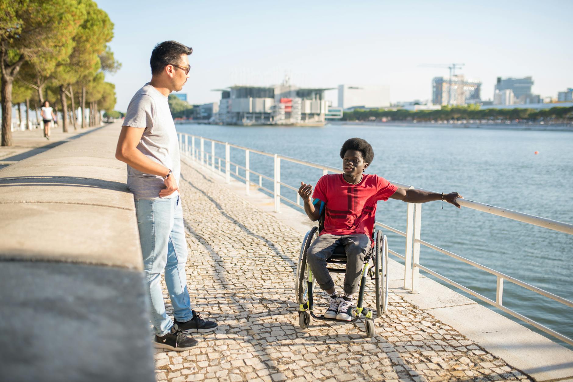 Wheelchair user by a riverside for Brisbane hotel and river access planning.