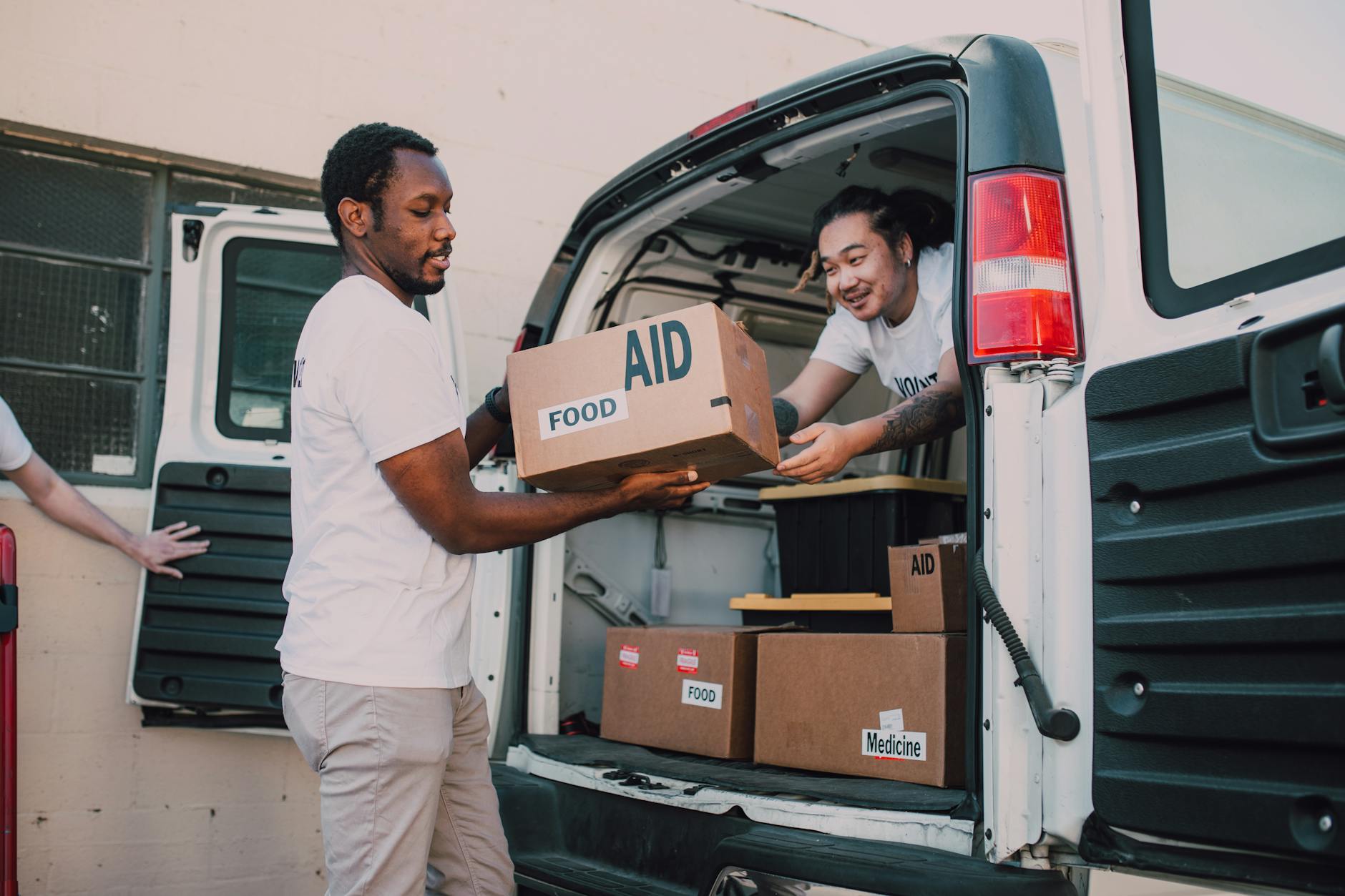 Volunteers loading aid boxes for Brisbane donation planning.