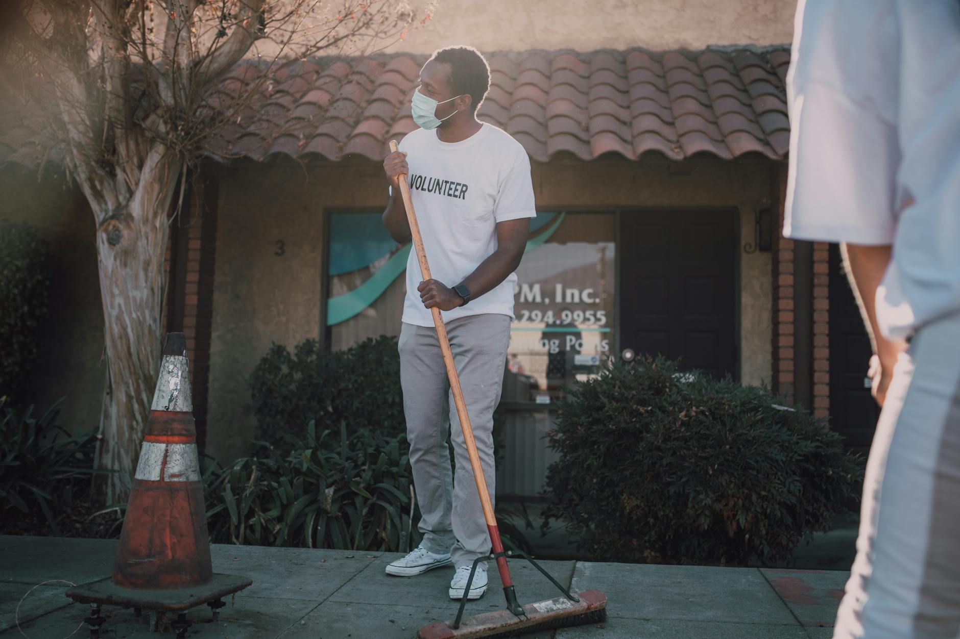 Volunteer cleaning a sidewalk for Brisbane field safety planning.