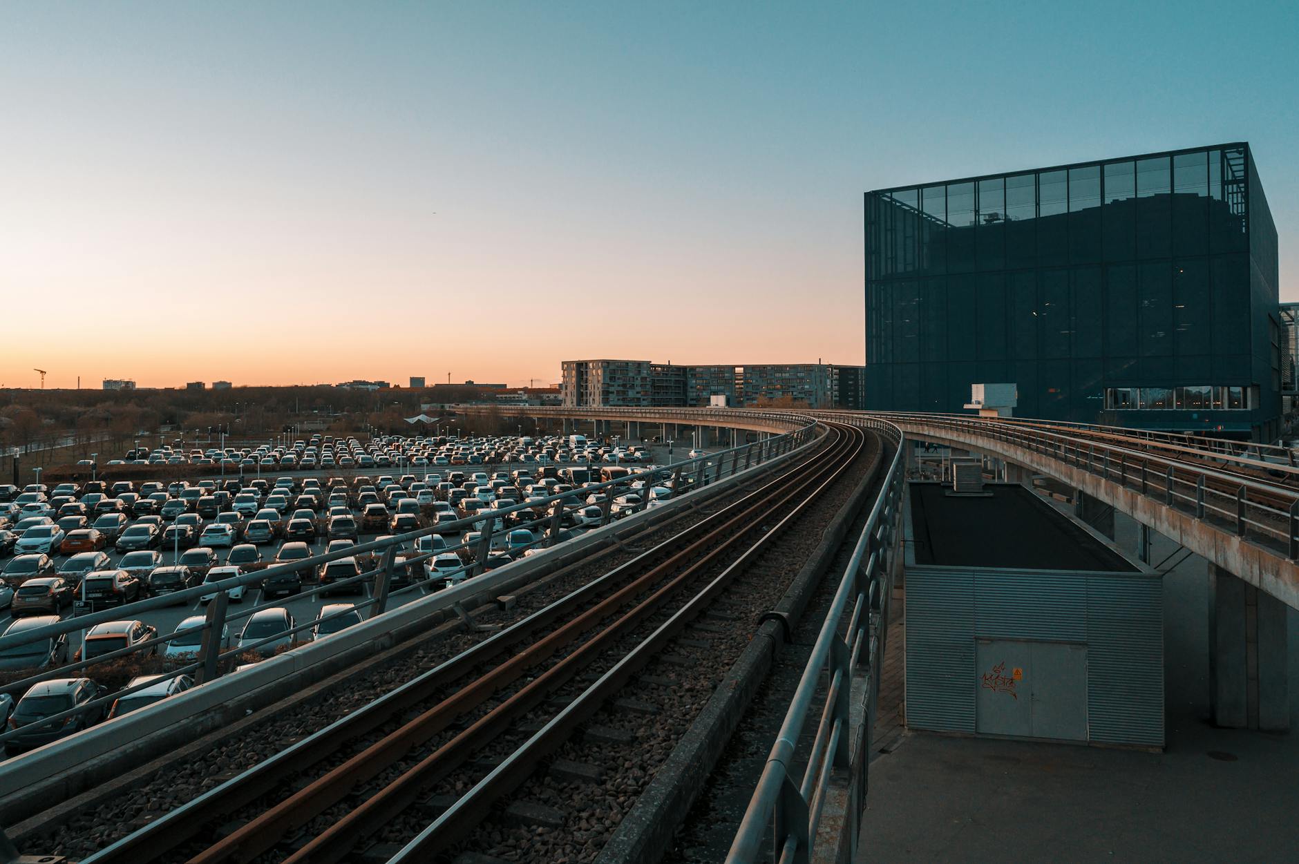 Copenhagen rail tracks near modern buildings for business buffer planning.