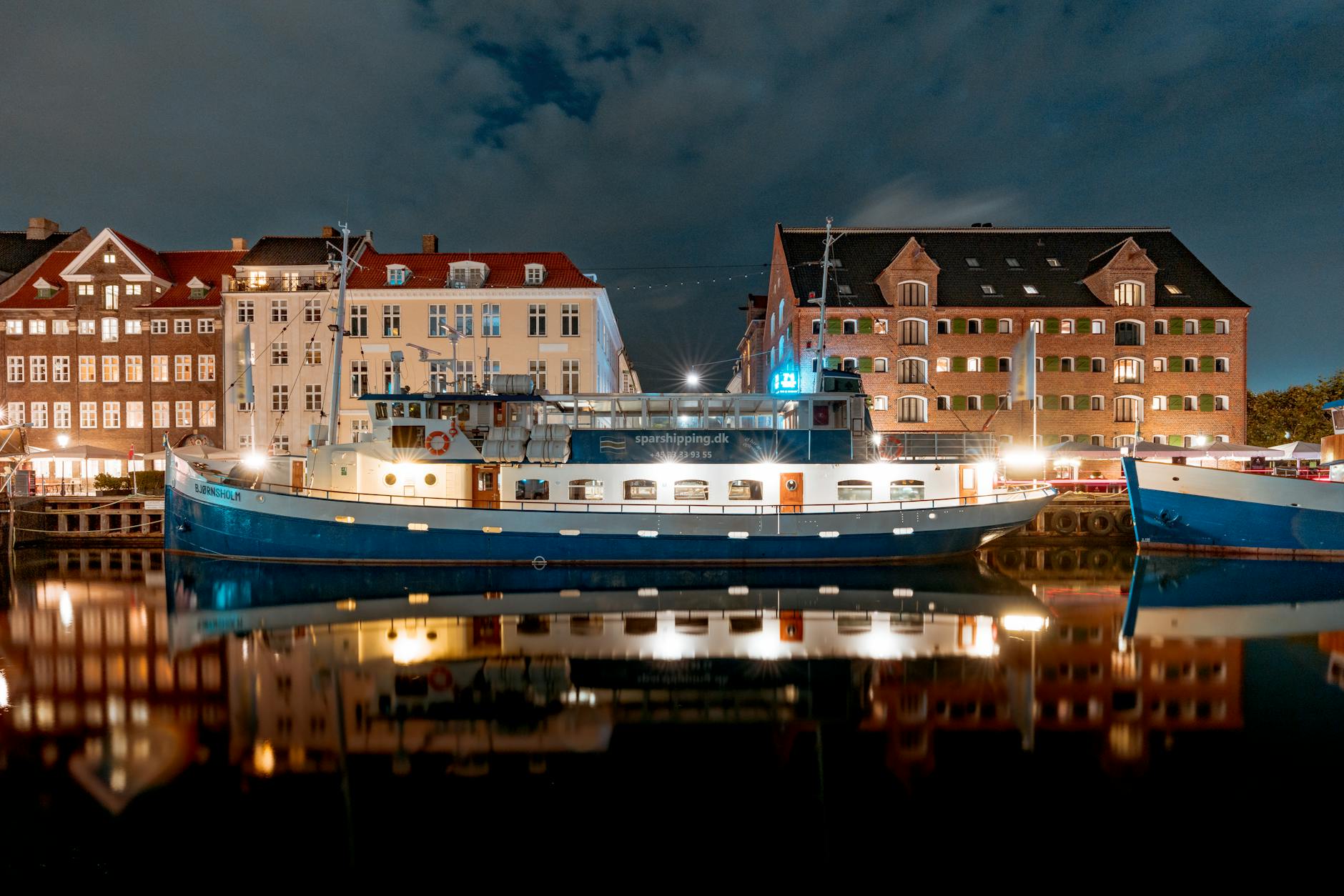 Copenhagen waterfront at night for conference arrival timing.
