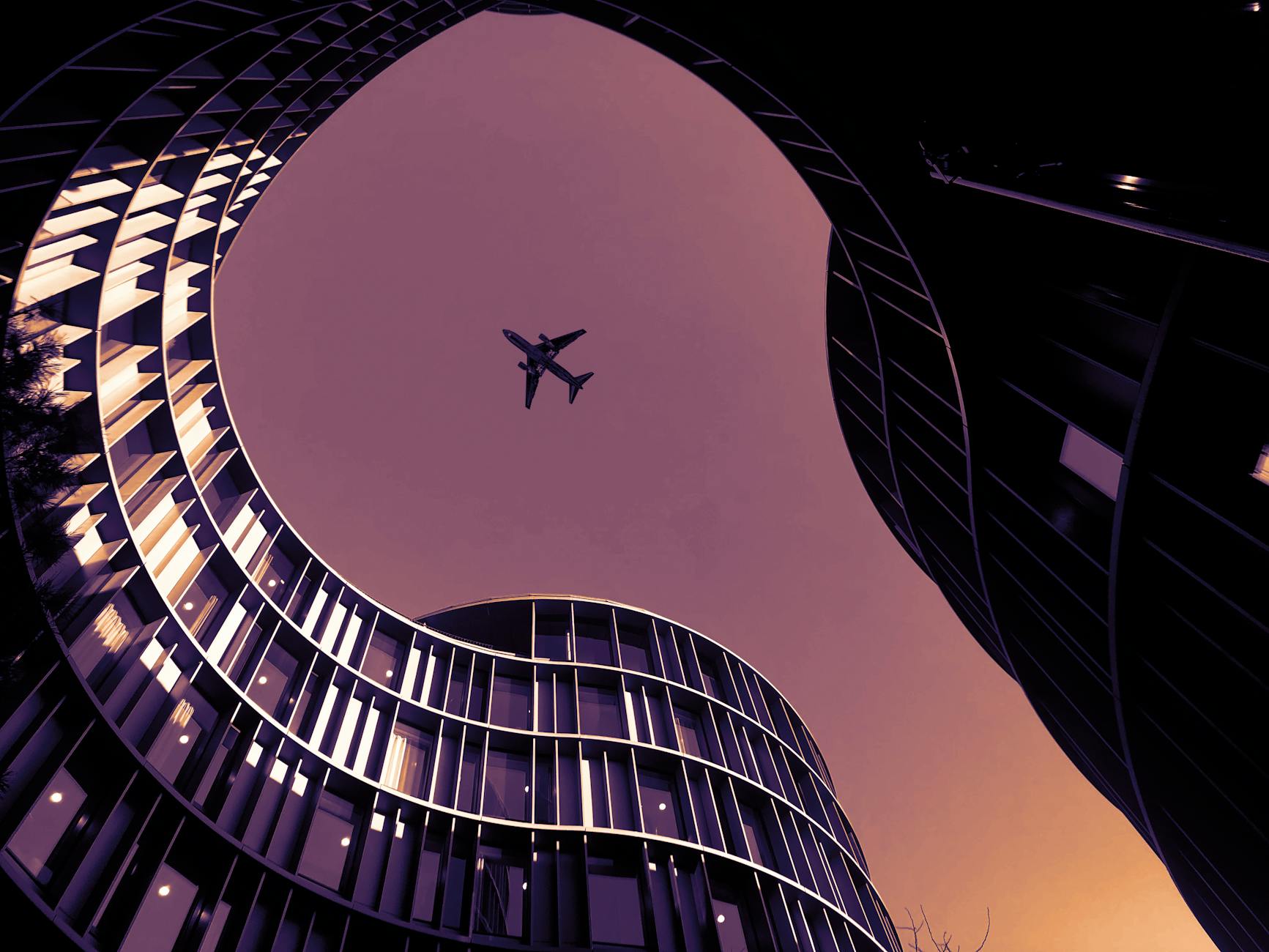 Airplane over Copenhagen buildings for consultant departure planning.