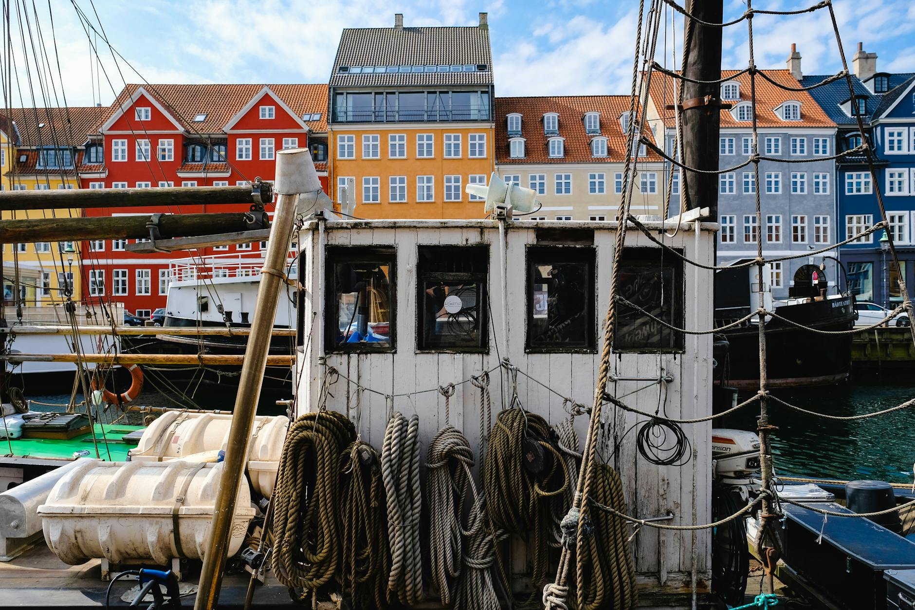 Nyhavn boats and colorful buildings for Copenhagen port-call harbor planning.