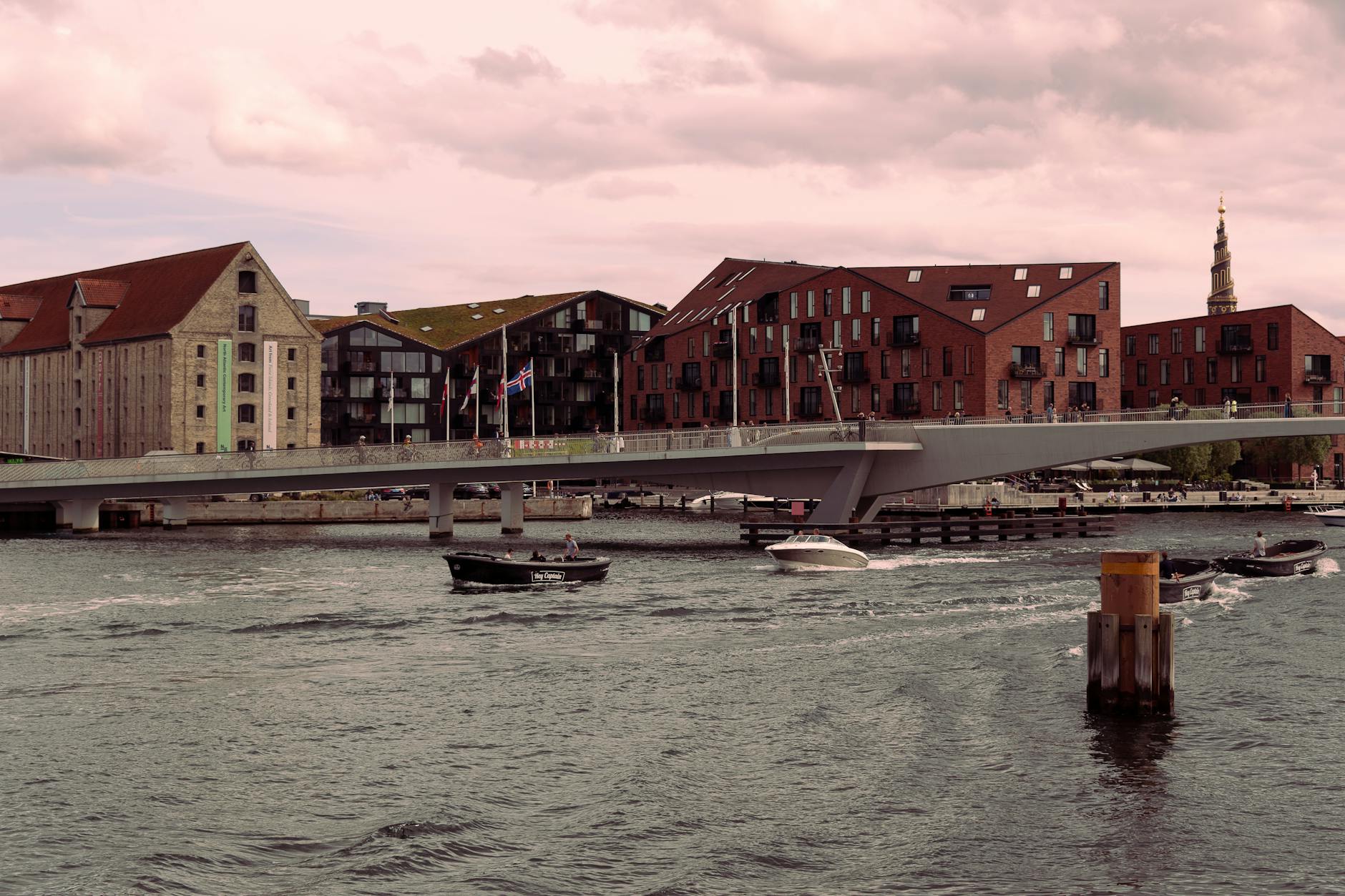 Copenhagen waterfront bridge at dusk for harbor route planning.