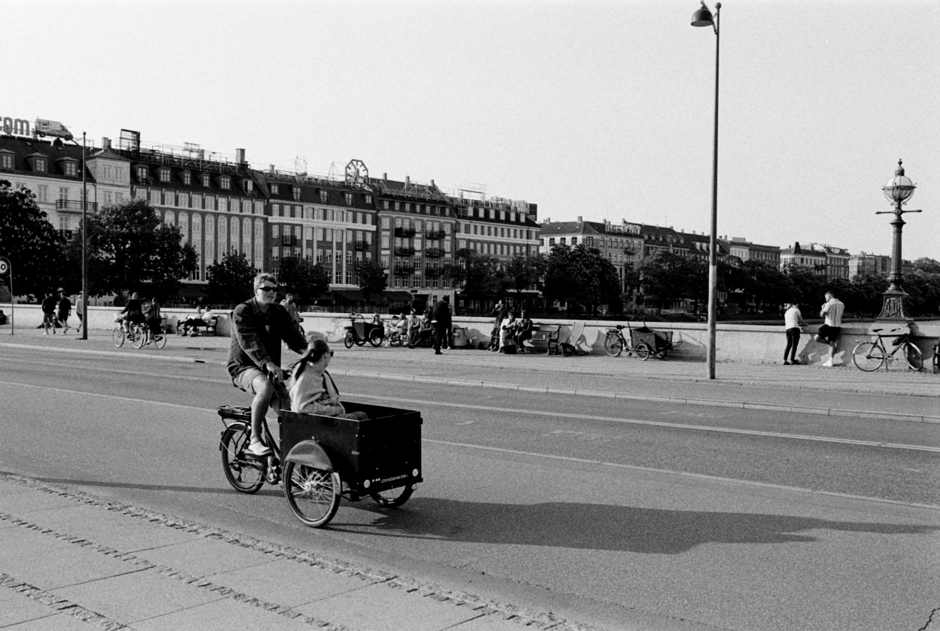 Cyclist on a Copenhagen street for bike-aware first visit planning.