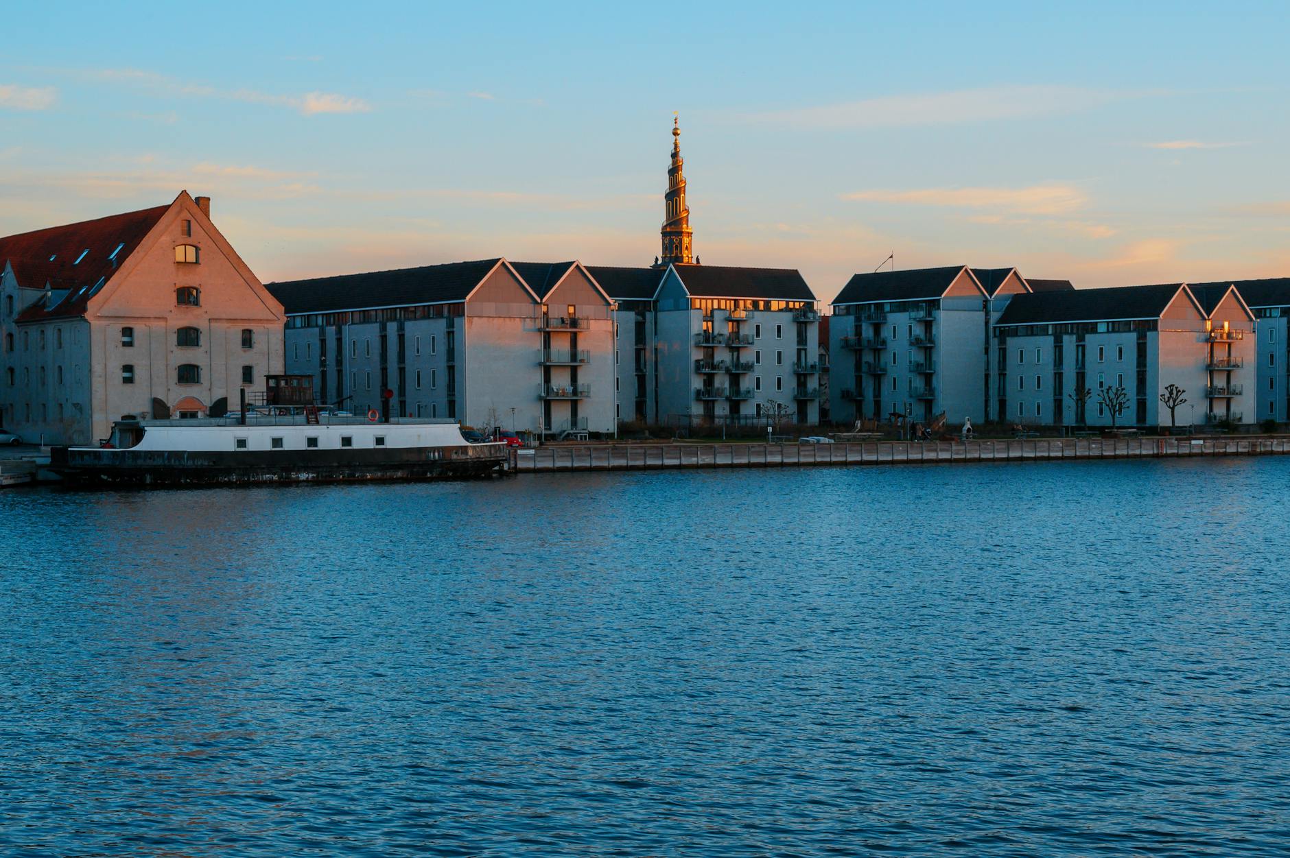 Copenhagen waterfront residences at sunset for luxury harbor planning.