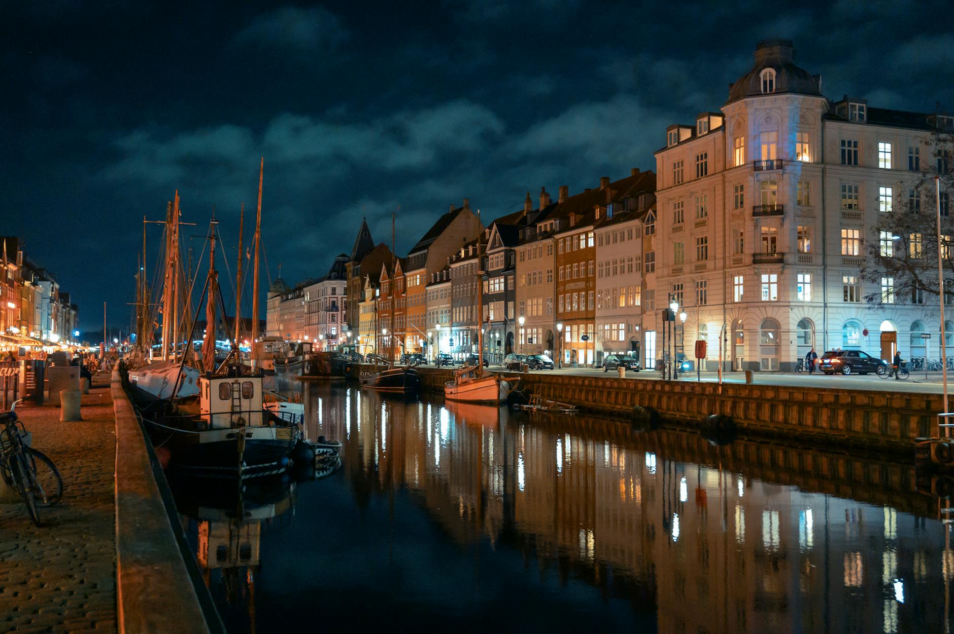 Nyhavn reflections at night for Copenhagen recovery planning.