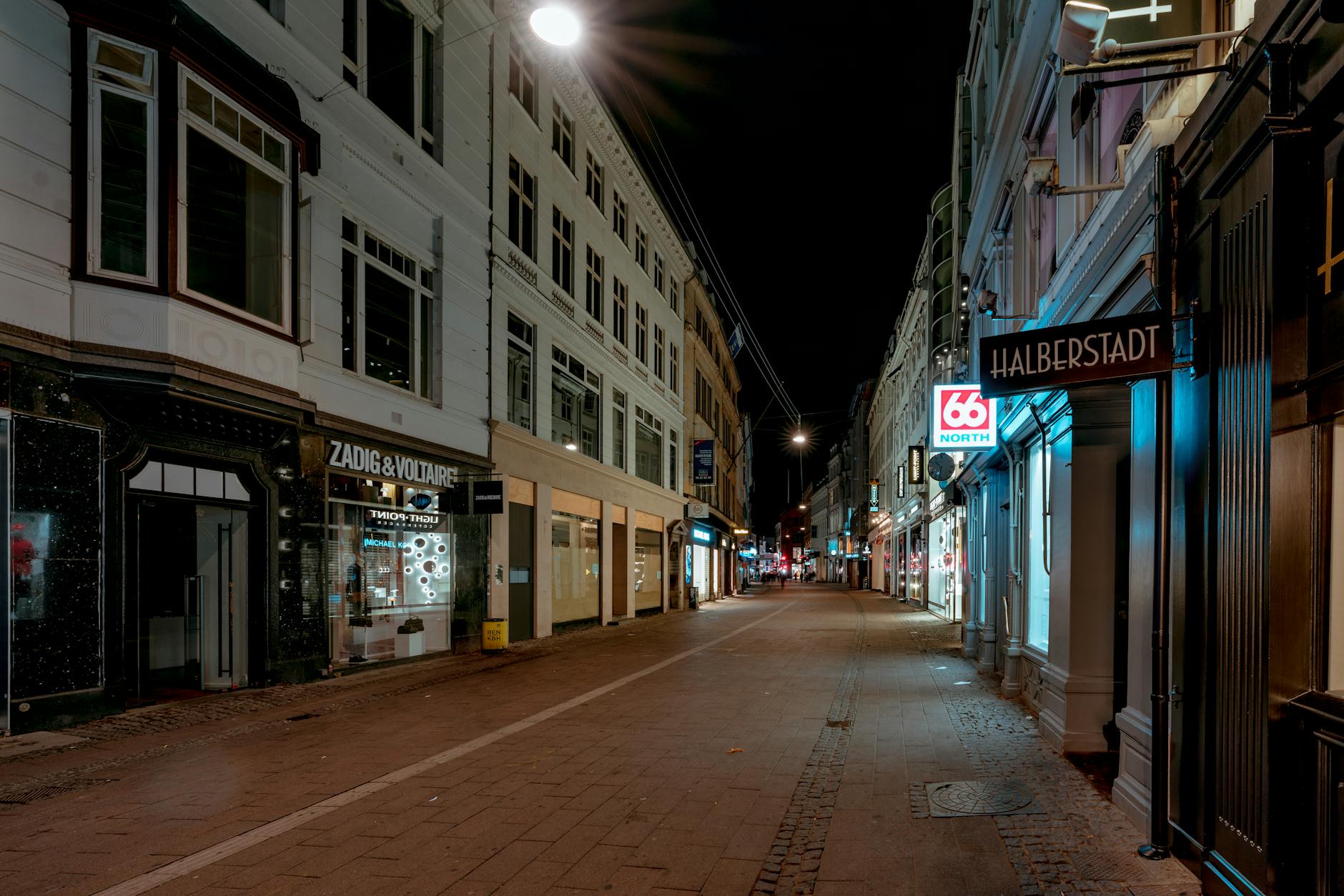 Quiet central Copenhagen street at night for bar district planning.