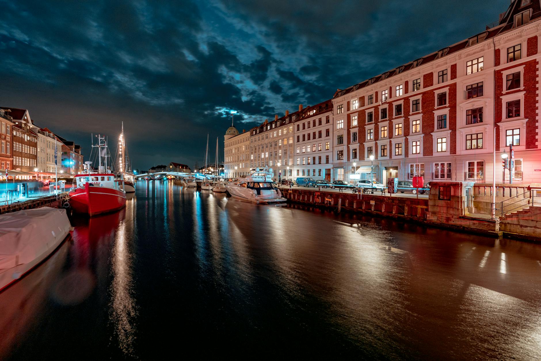 Illuminated Nyhavn canal in Copenhagen for scenic nightlife planning.