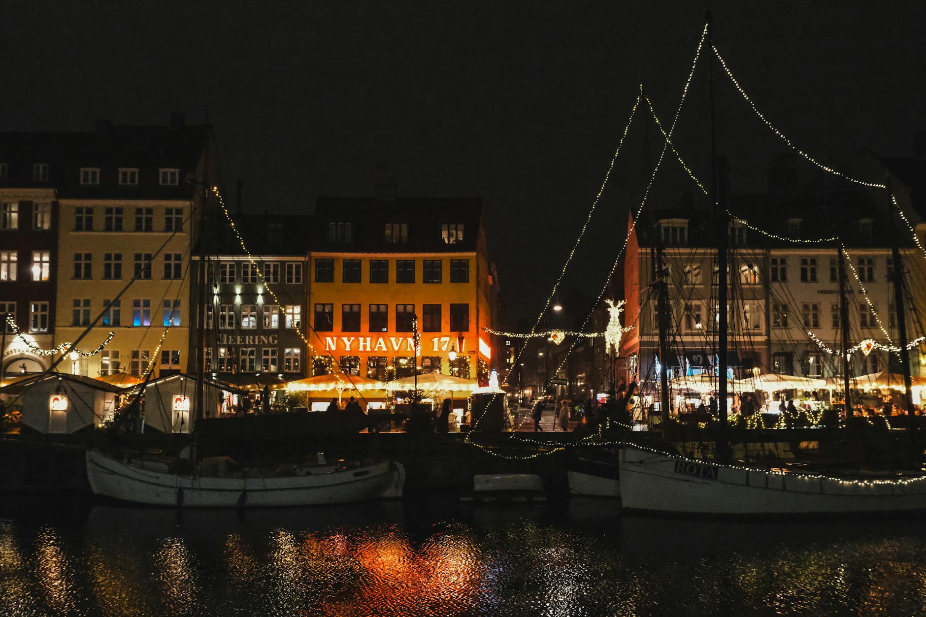 Nyhavn at night in Copenhagen for late-return planning.