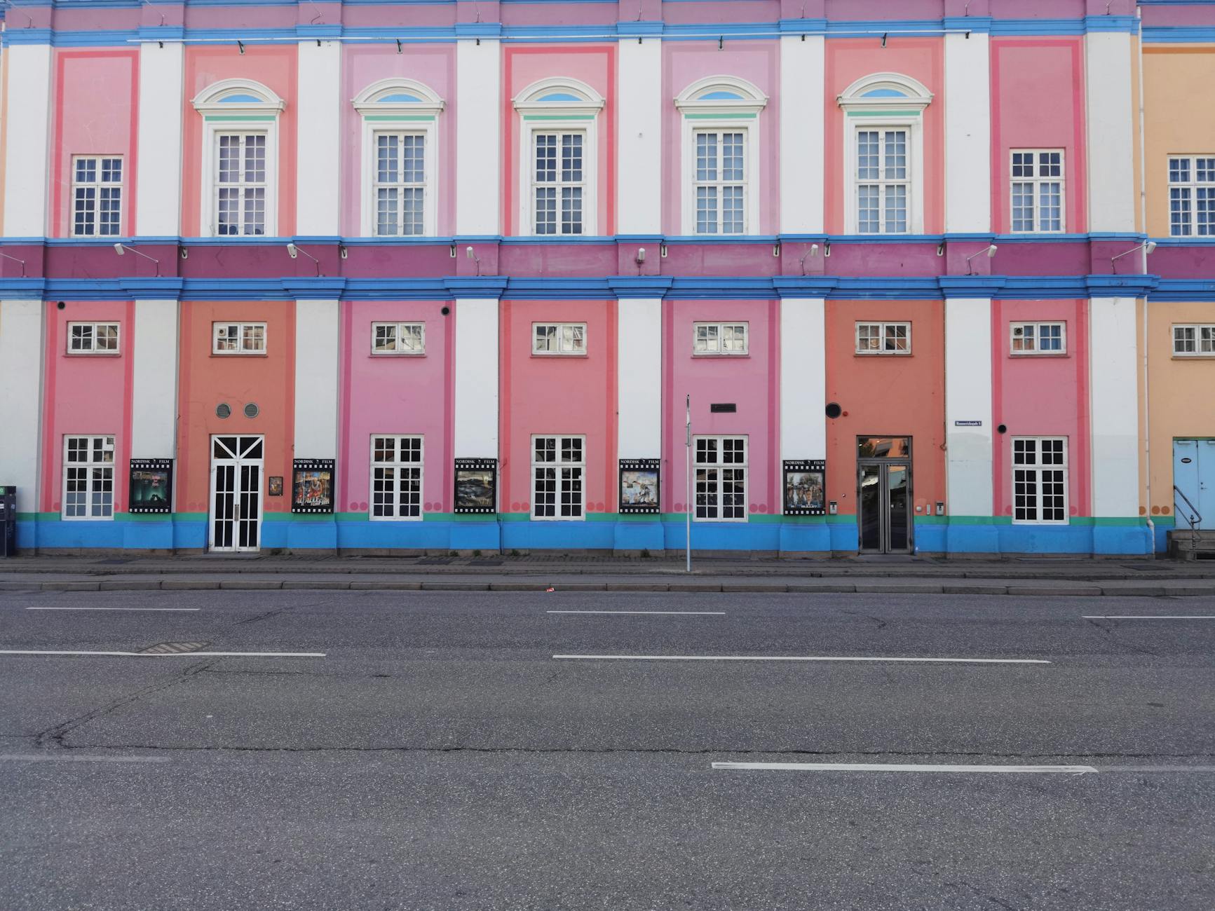 Pastel Copenhagen facade for repeat visitor neighborhood planning.