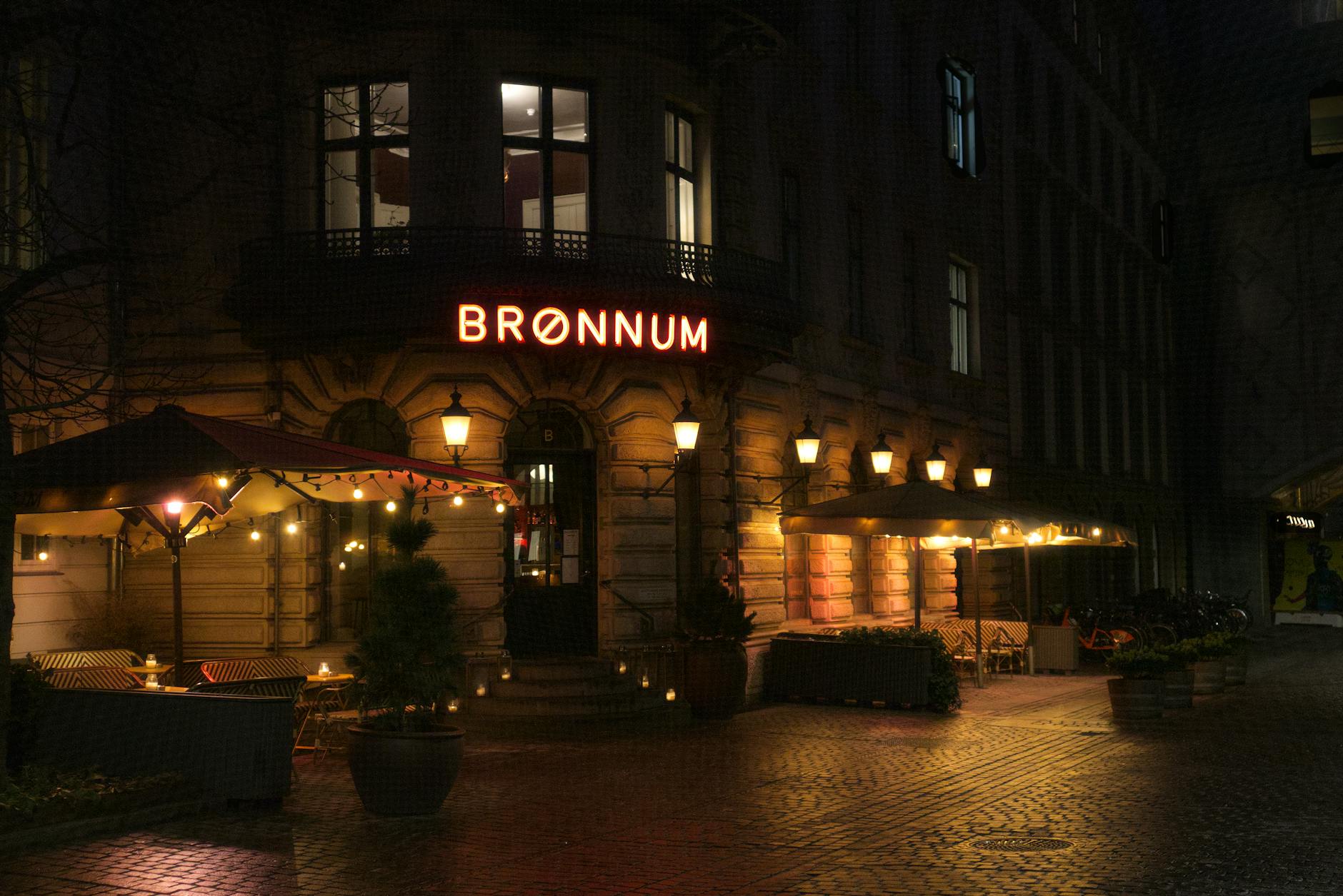 Warm Copenhagen cafe at night for repeat visitor dining planning.