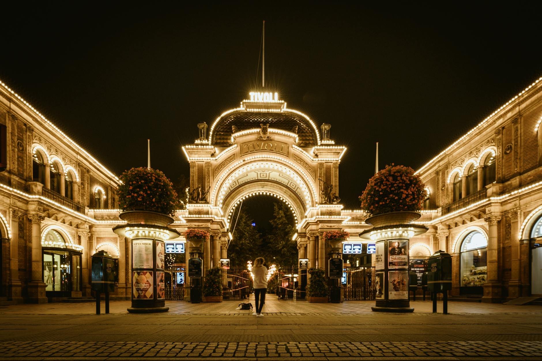 Lit Tivoli Gardens entrance in Copenhagen for tourist evening planning.