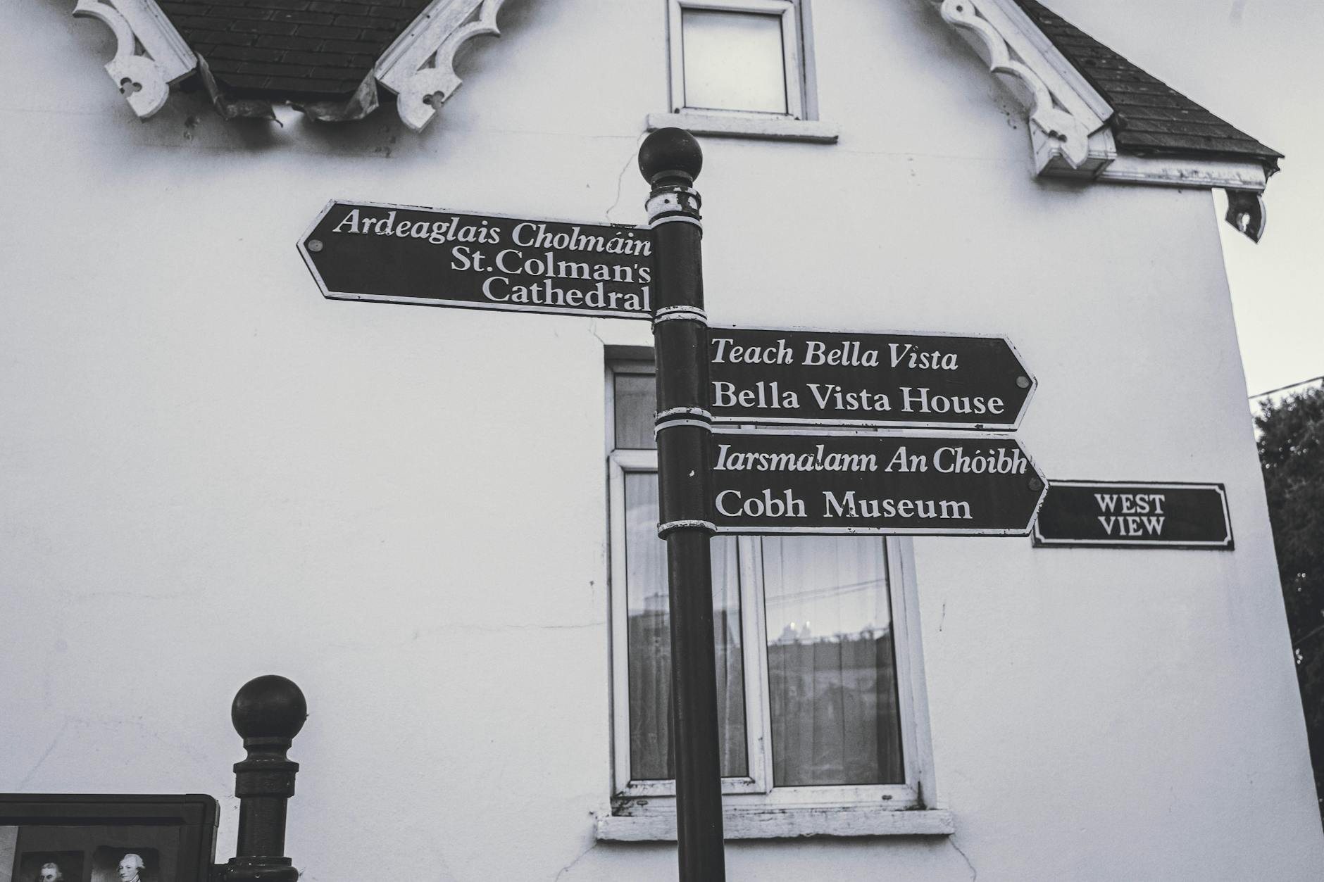 Historic signpost directing to landmarks in Cobh, County Cork, Ireland.