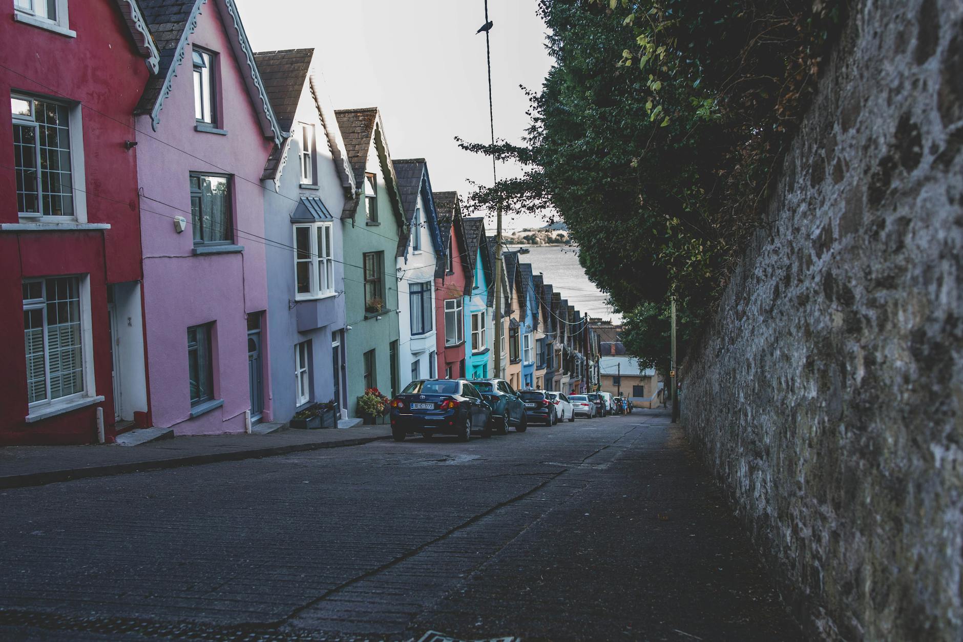 Vibrant row houses line the streets of historic Cobh, Ireland, showcasing colorful architecture.