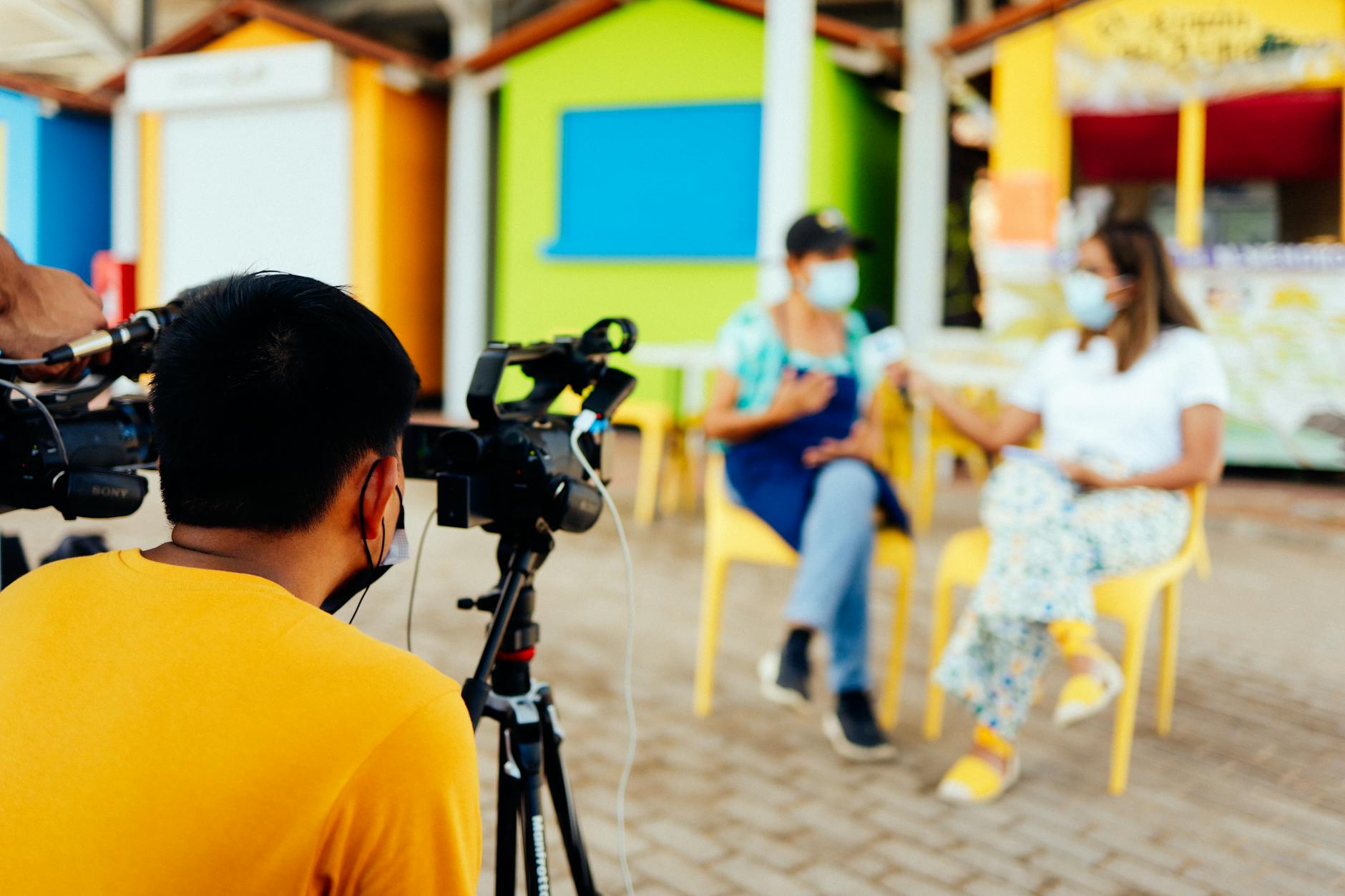 Camera crew filming an outdoor interview with professional video equipment.