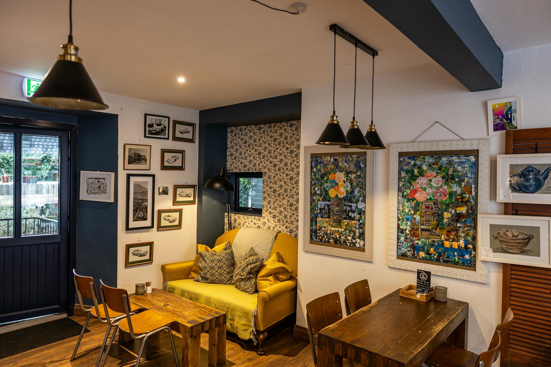 Charming cafe interior with vintage decor and art-lined walls in Kinsale, Ireland.