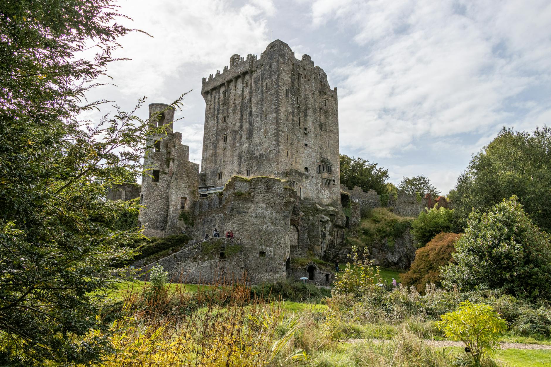 Historic Blarney Castle surrounded by lush greenery in Cork, Ireland.
