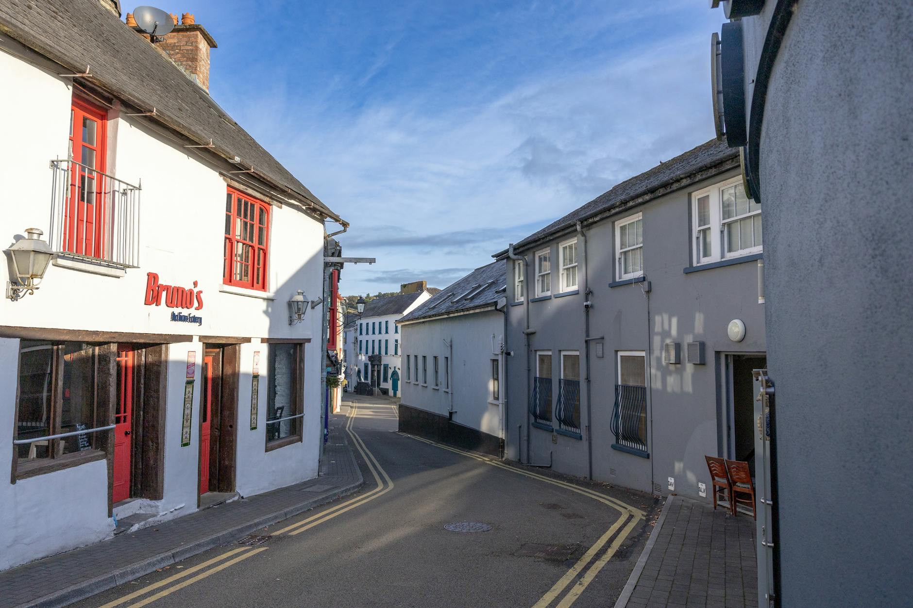 A picturesque street view in Kinsale, County Cork, Ireland, showcasing traditional architecture.