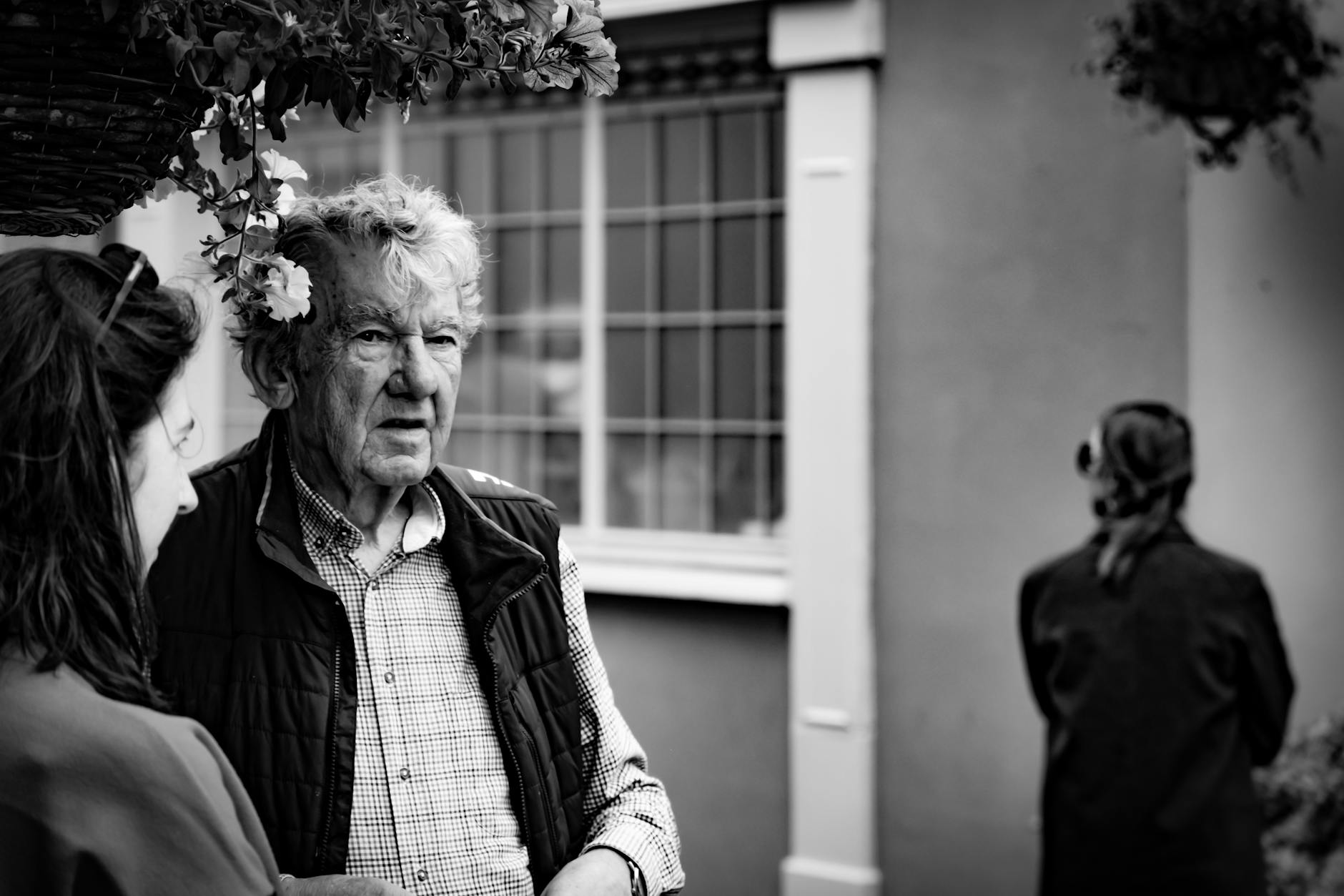 A candid street photo capturing a moment between two people in Kinsale, Ireland.