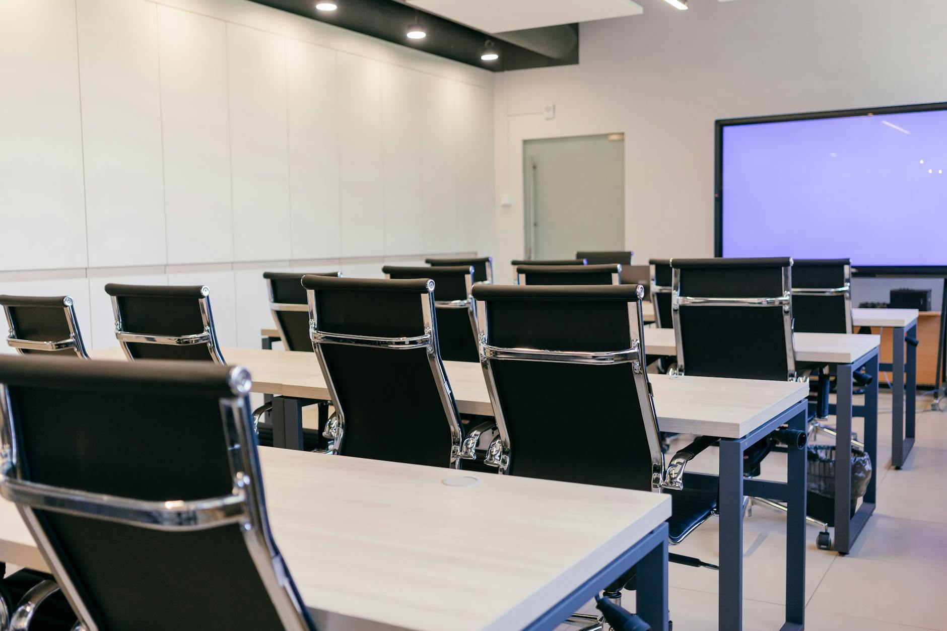 Modern conference room with projection screen for Delhi networking and session planning.