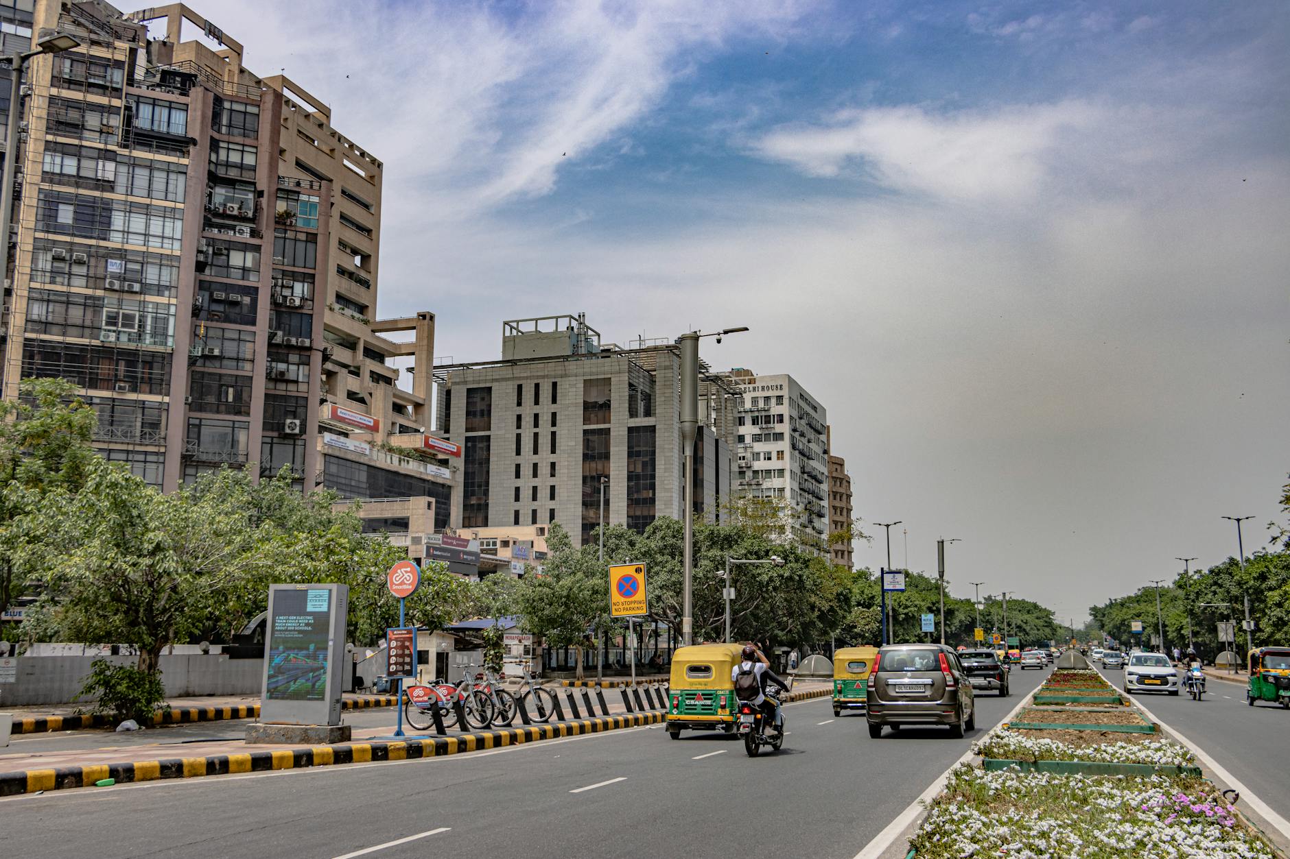 Modern architecture and street life in New Delhi for business visitor planning.