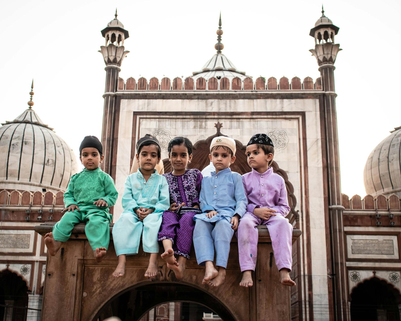 Children at Jama Masjid in New Delhi for family travel report planning.