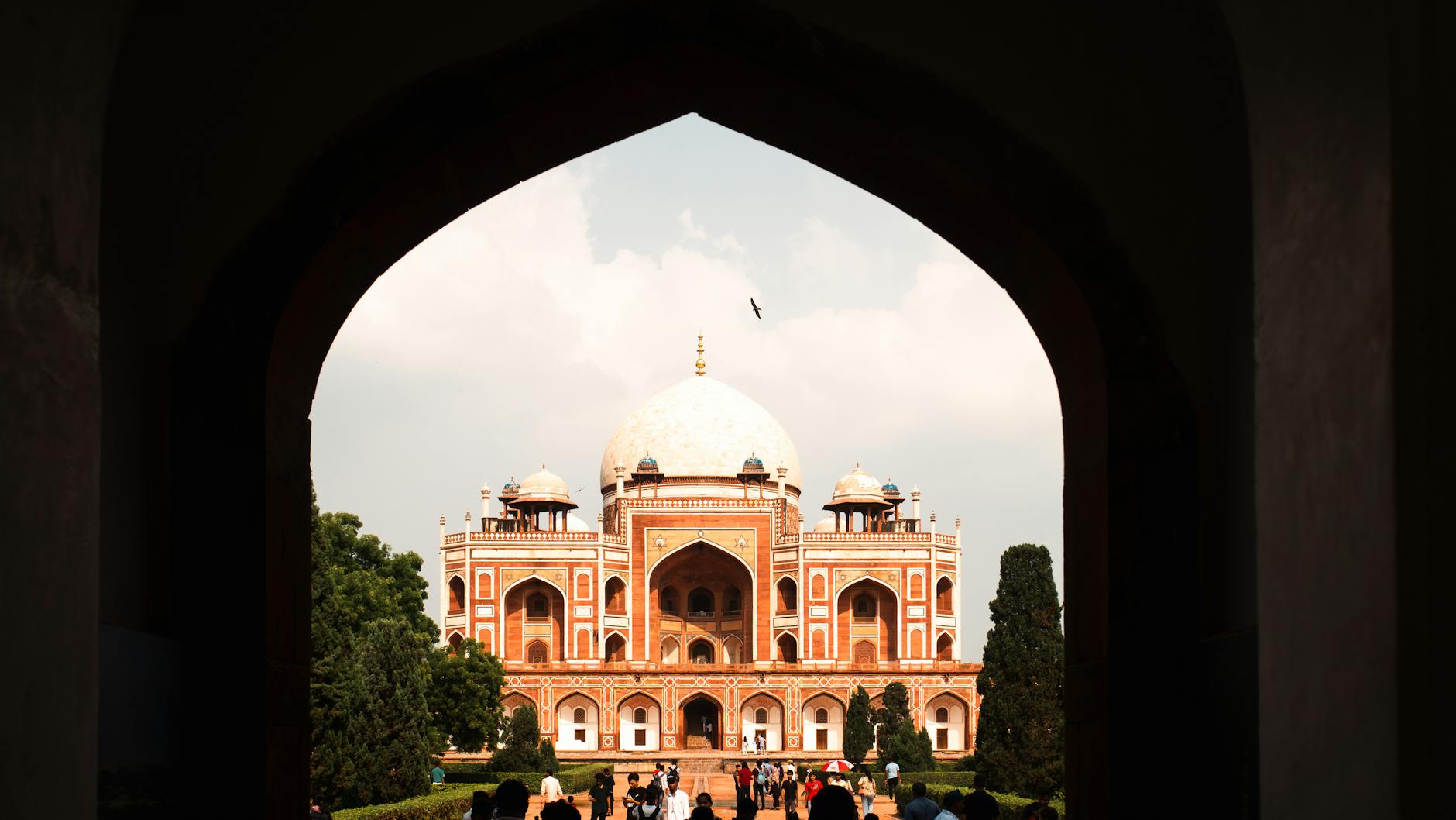 Humayun's Tomb framed by an archway for first-time Delhi travel report planning.