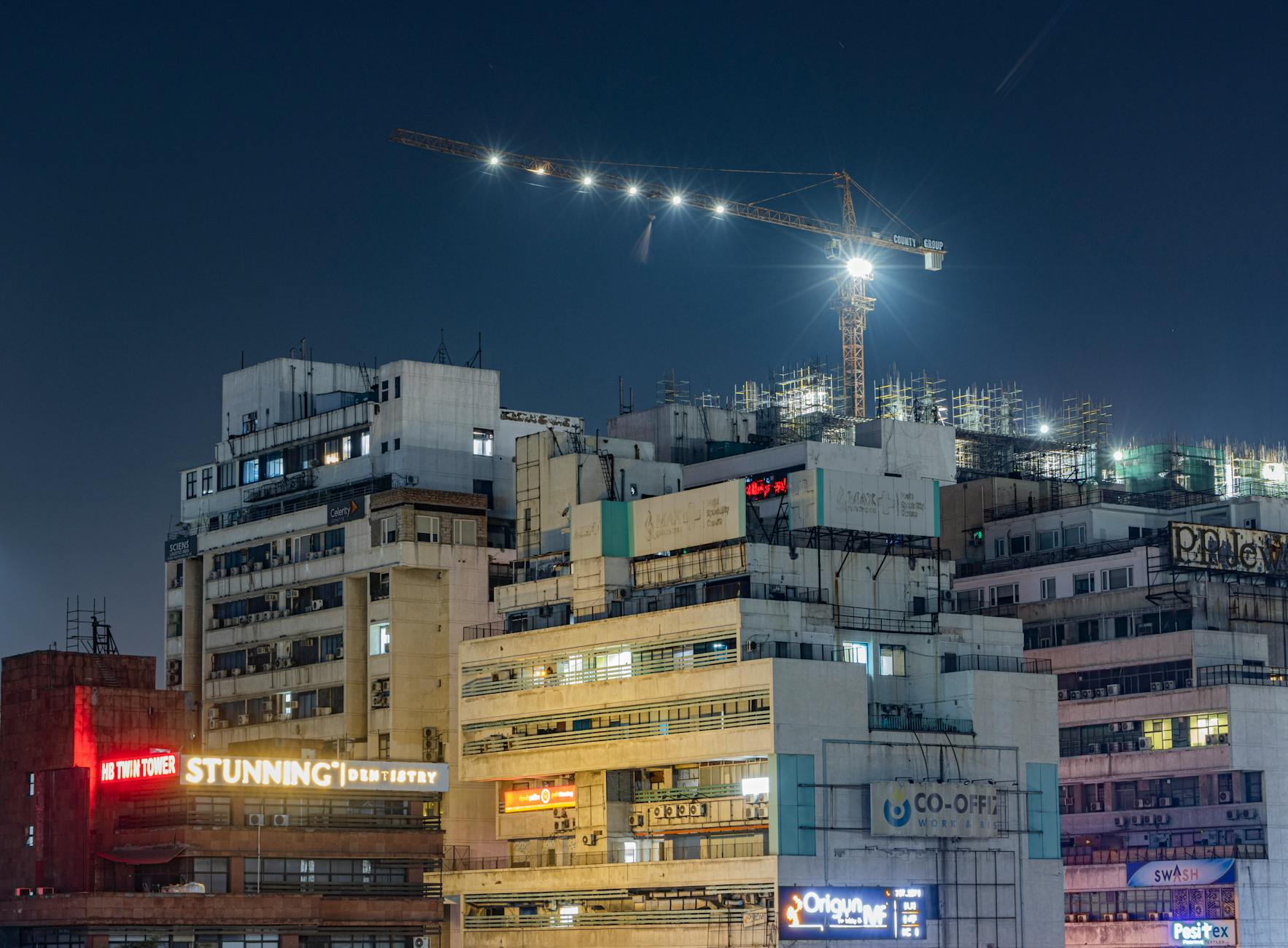 New Delhi high-rises at night for luxury evening planning.