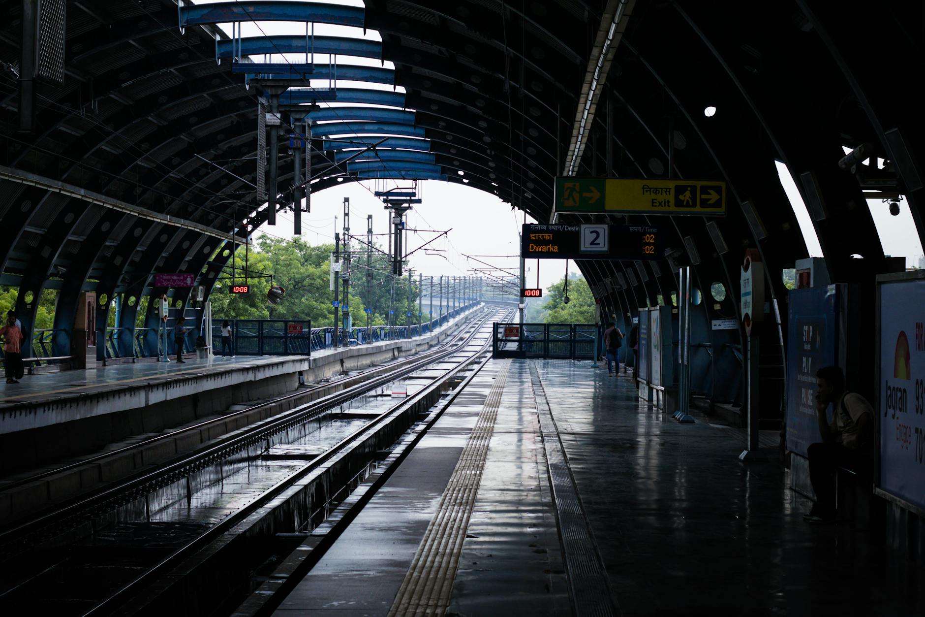 Quiet New Delhi metro station after rain for older traveler transport planning.