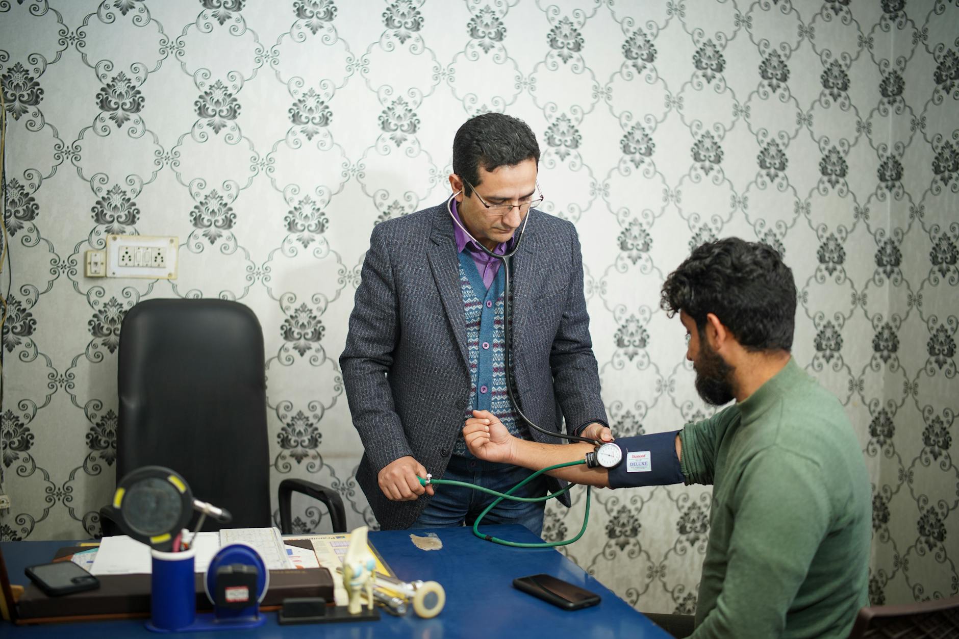 Doctor checking blood pressure for travel health planning.