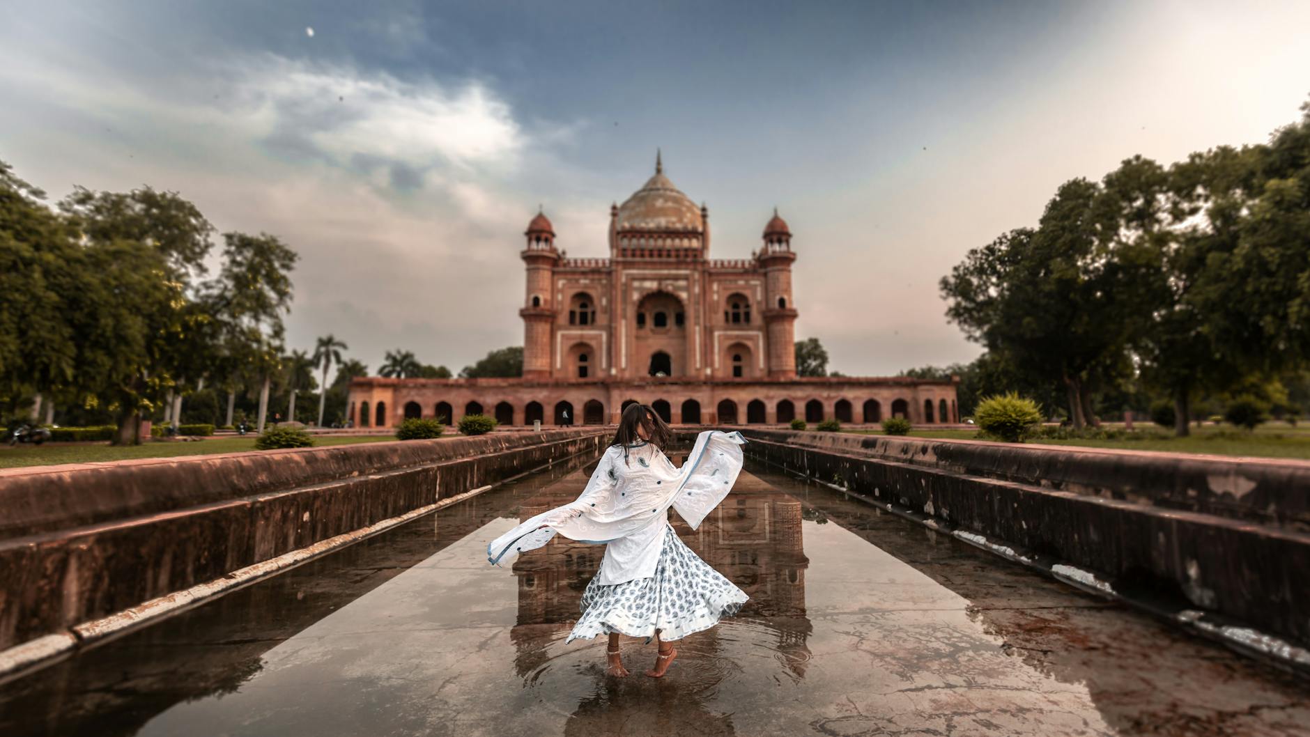 Woman in traditional dress near Safdarjung's Tomb for Delhi clothing planning.