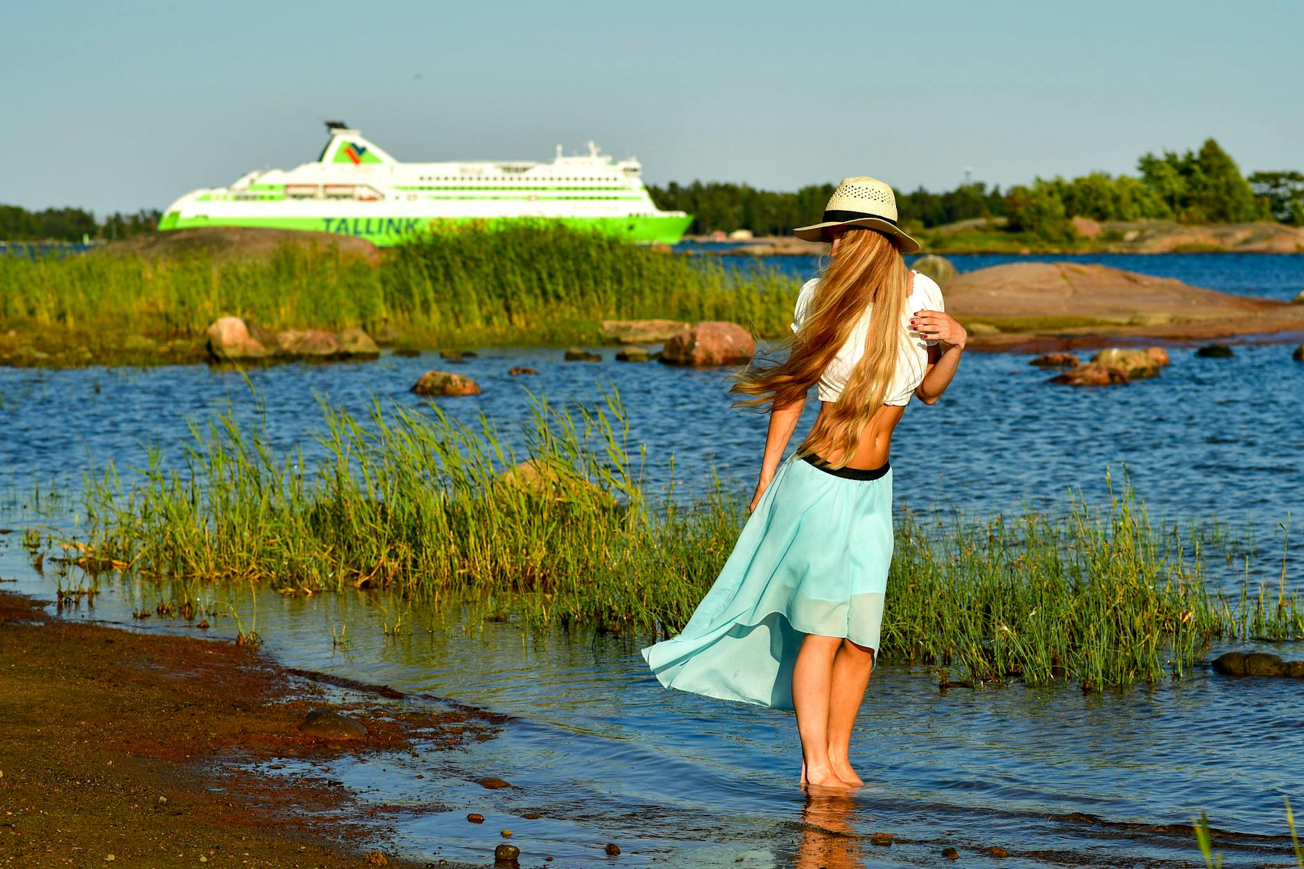 Helsinki beach and passing ship for outdoor travel planning.