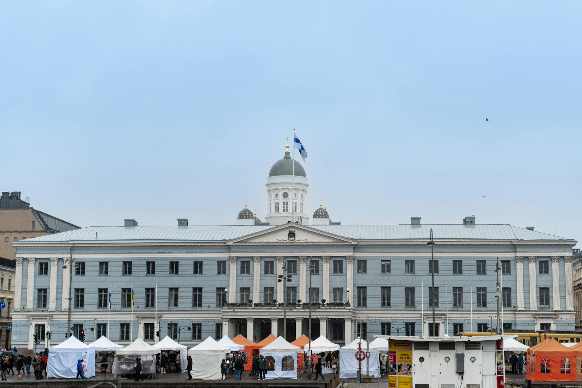 Helsinki City Hall and market stalls for conference attendee planning.