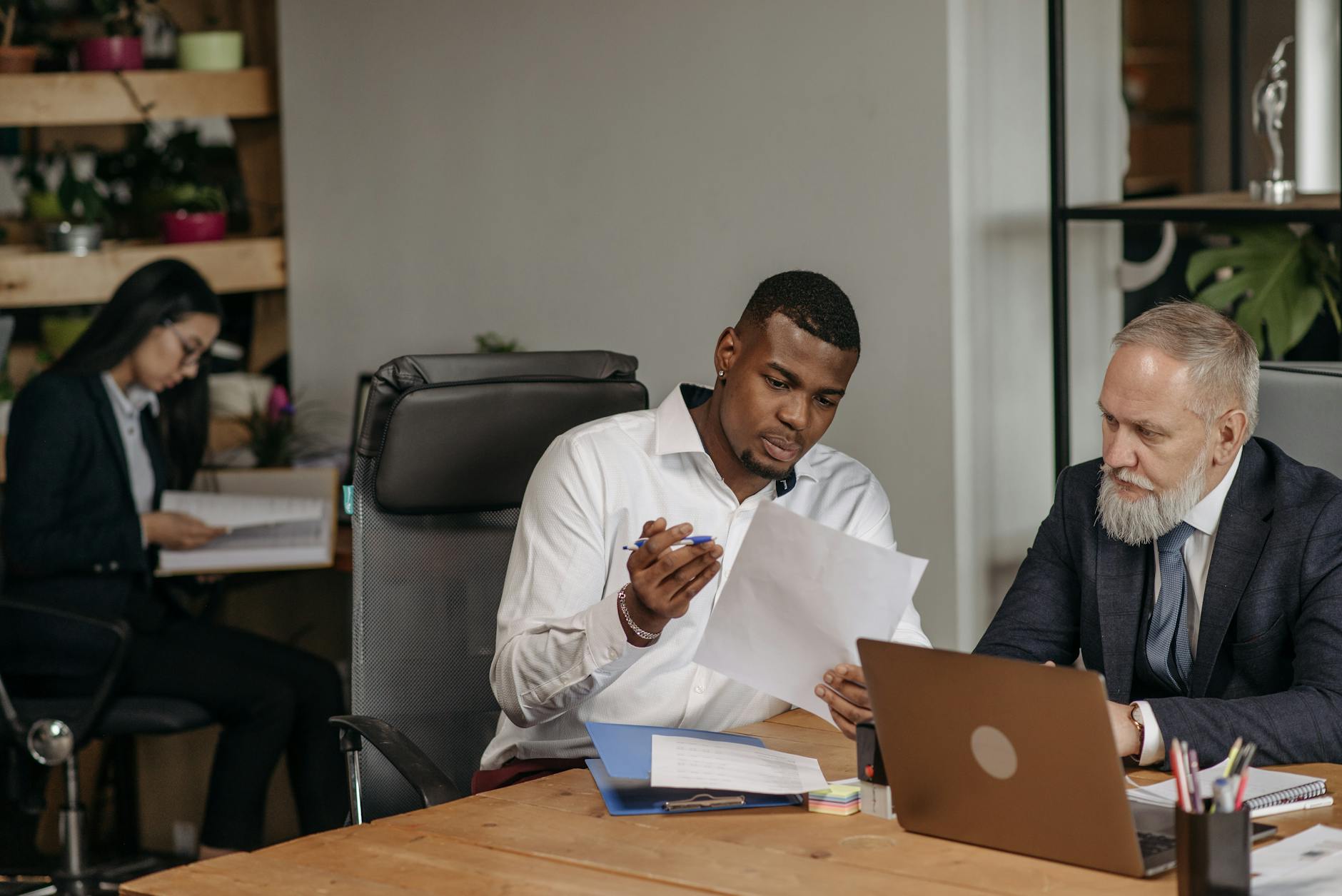 Professionals reviewing documents for Helsinki consultant follow-up planning.
