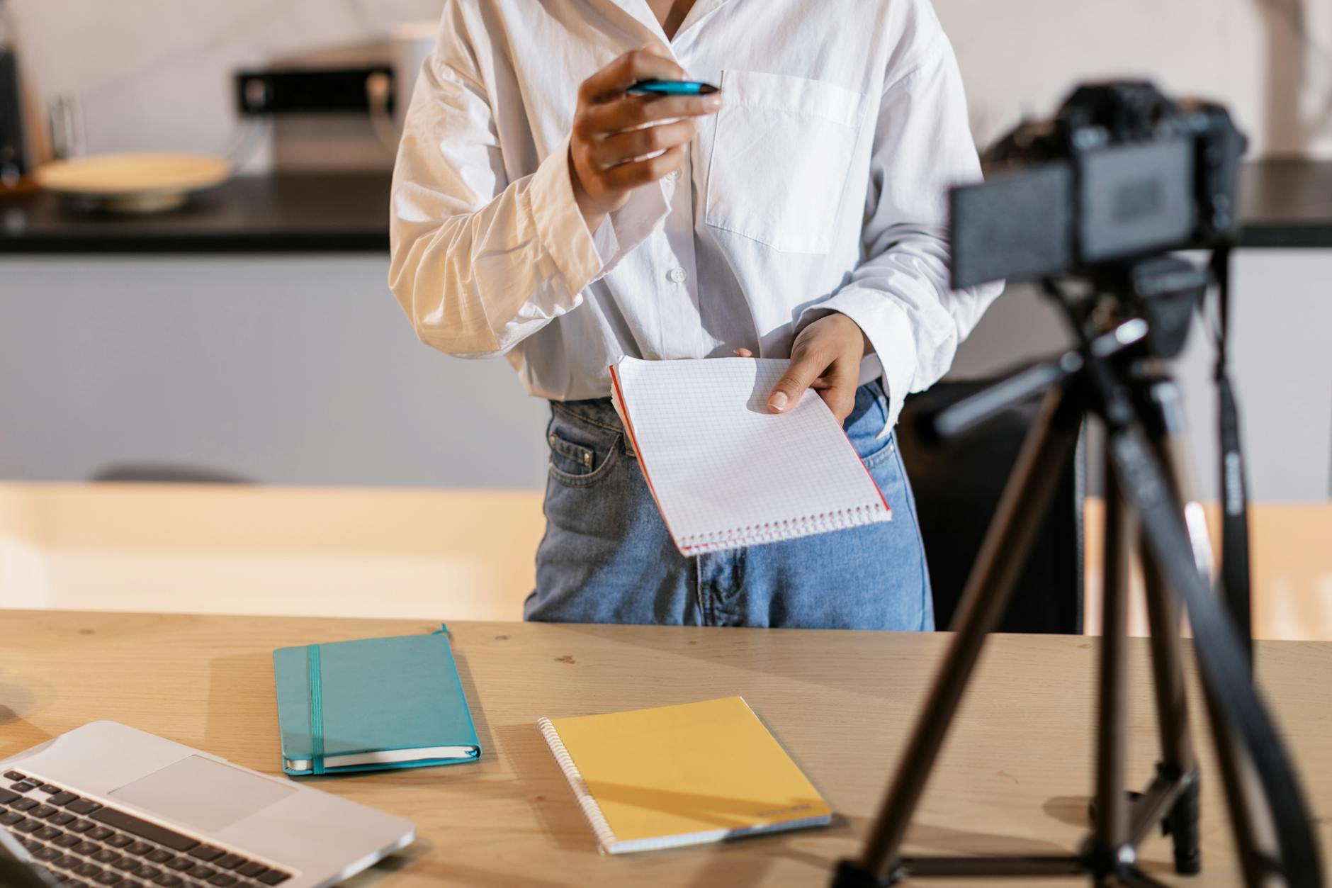 Creator with notes and camera for Helsinki editing and posting planning.