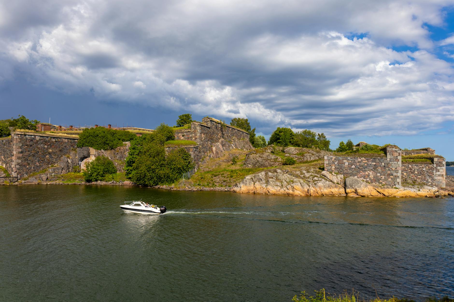 Boat passing Suomenlinna Fortress for Helsinki port-call report planning.
