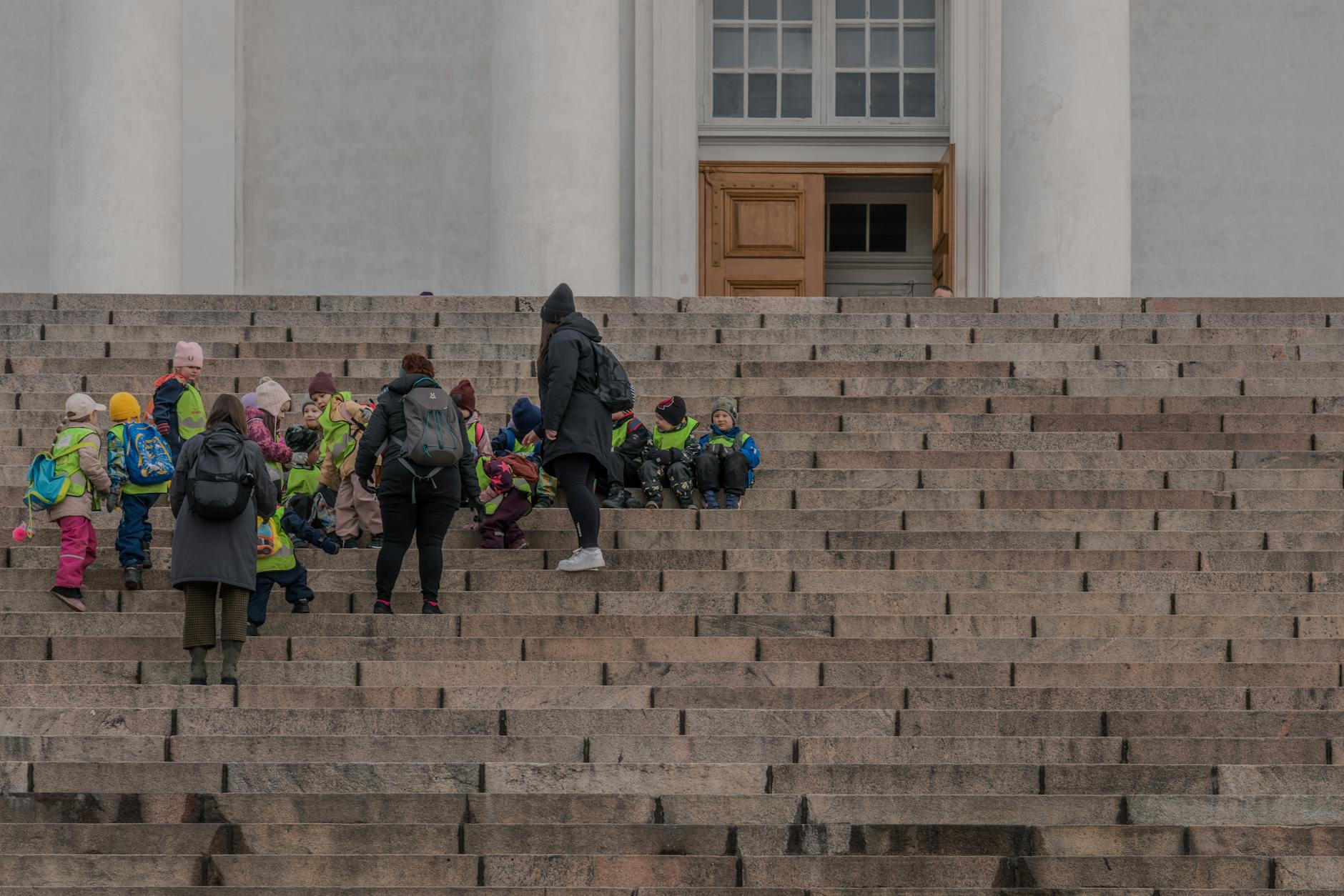 Children on the steps of Helsinki Cathedral for family day planning.