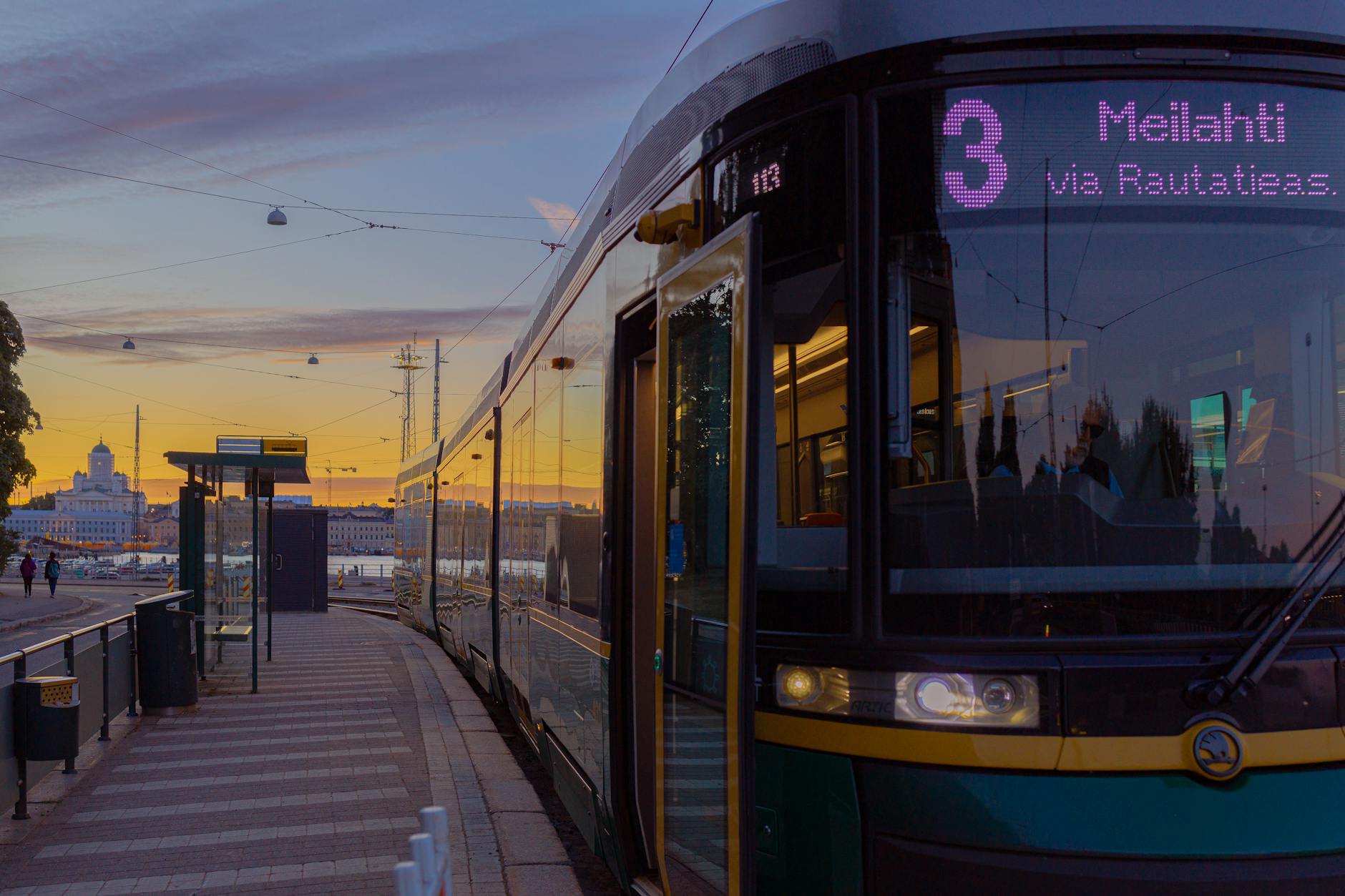 Helsinki tram at sunset for first-time transit planning.