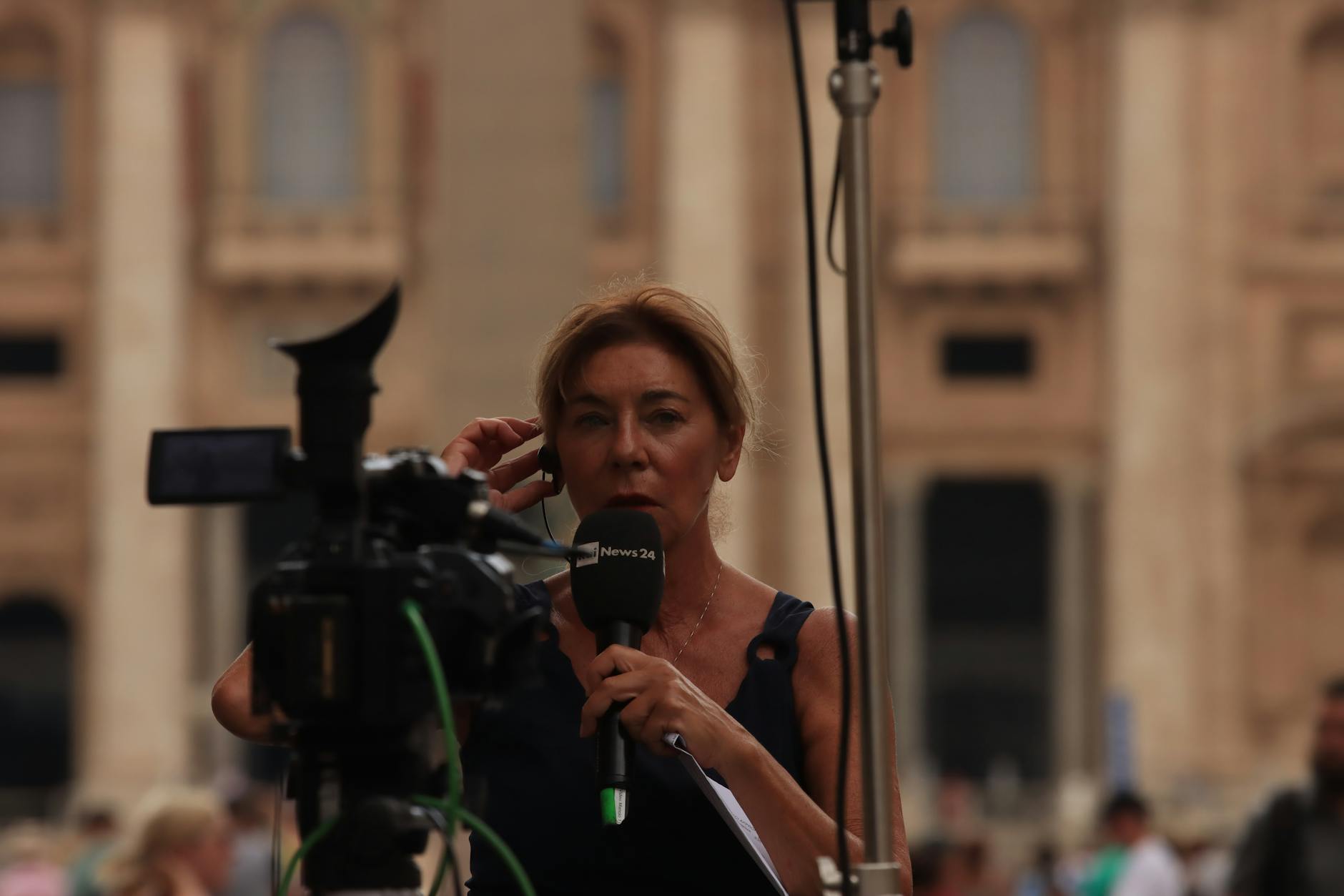 Reporter with microphone for Helsinki reporting-frame planning.