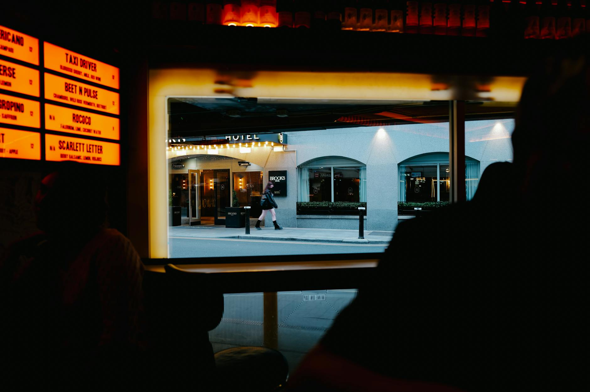 Dim bar view toward a city street for Helsinki late-return planning.