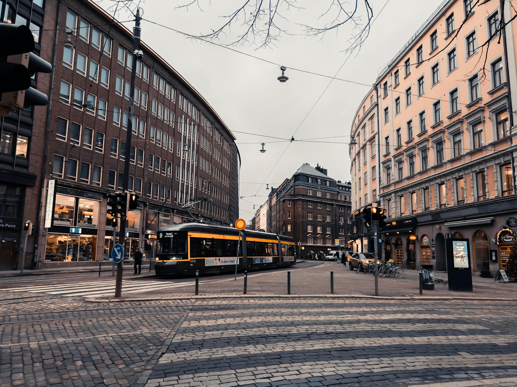 Evening Helsinki tram street for older traveler weather planning.