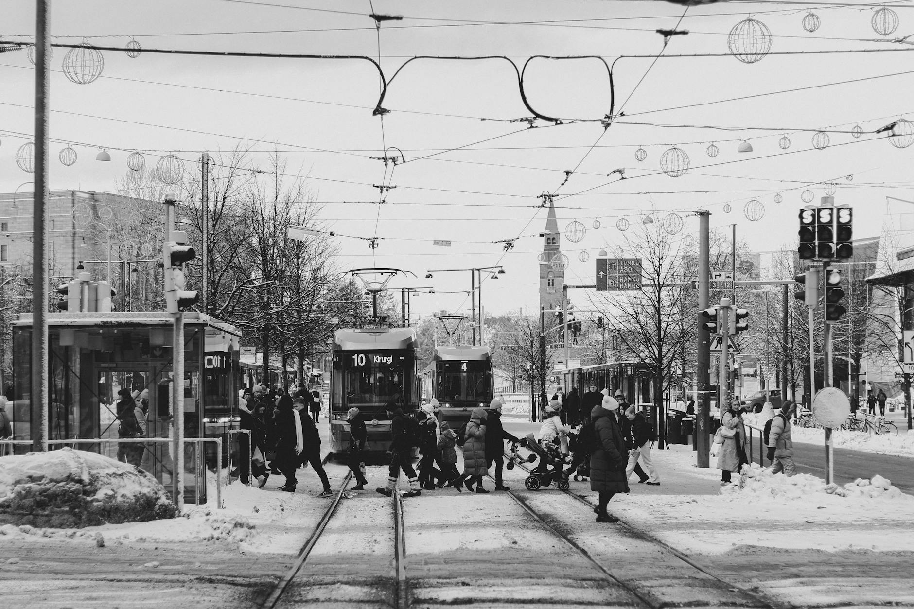 Winter trams and pedestrians in Helsinki for older traveler lodging planning.