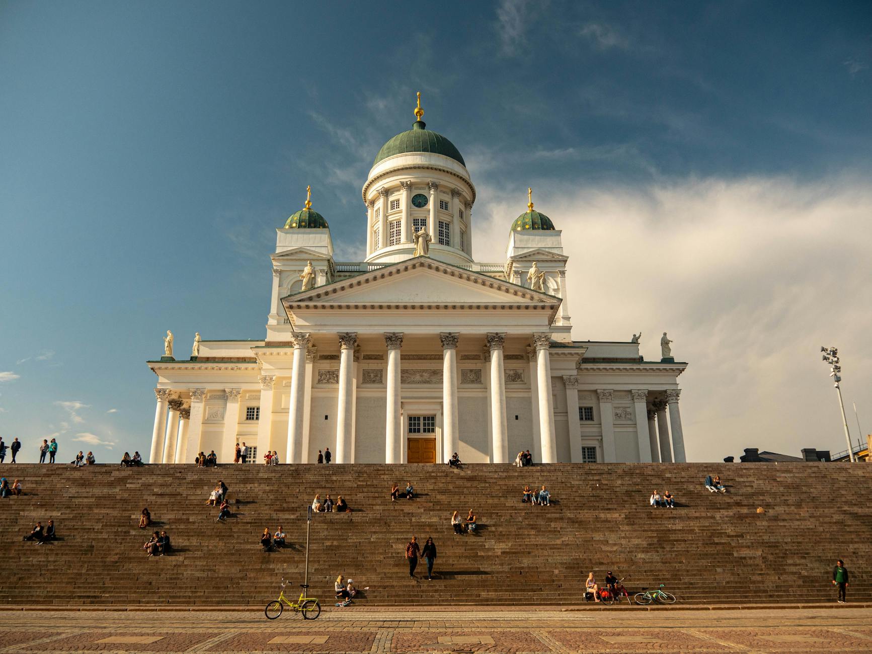 Visitors on Helsinki Cathedral steps for tourist landmark planning.