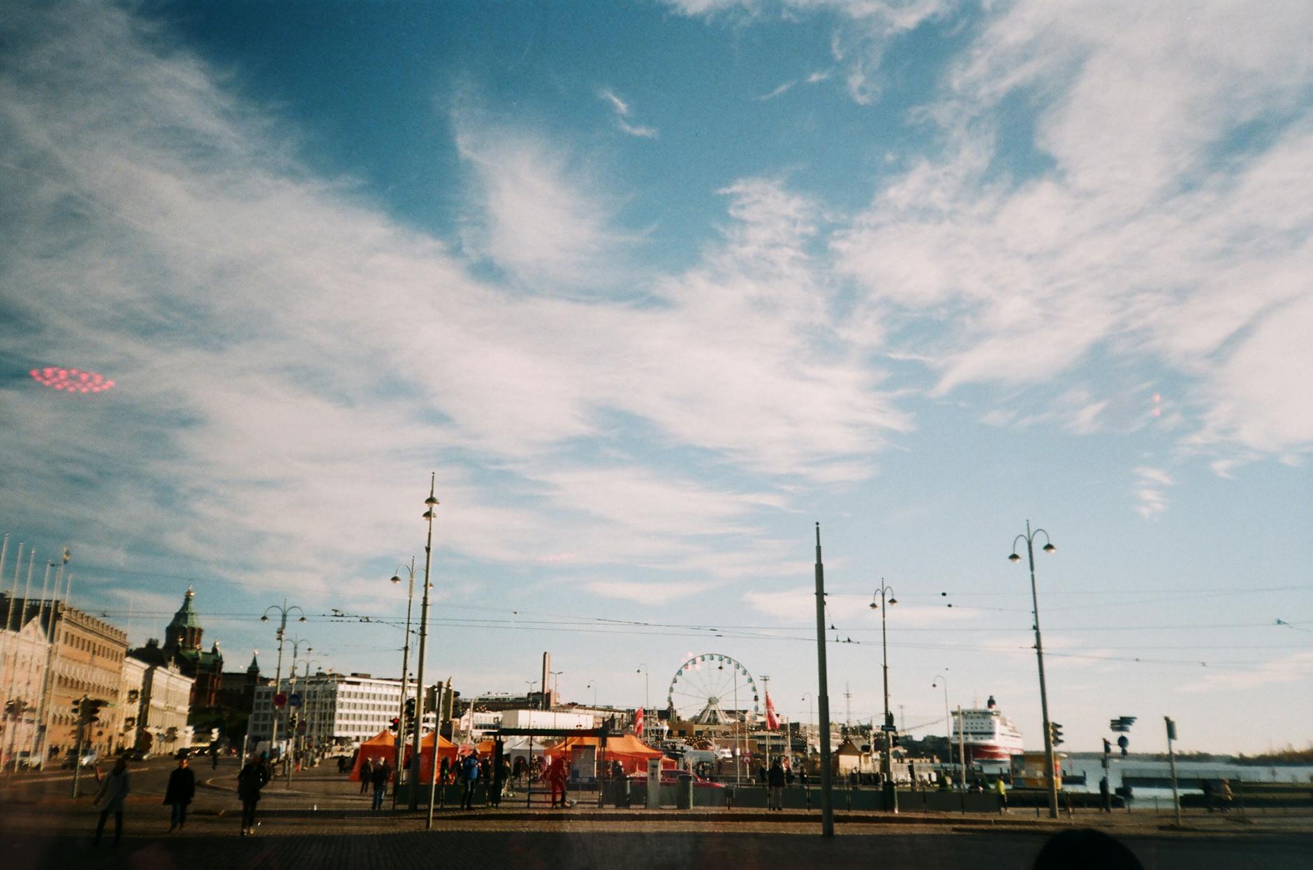 Helsinki Ferris wheel and city skyline for tourist planning.