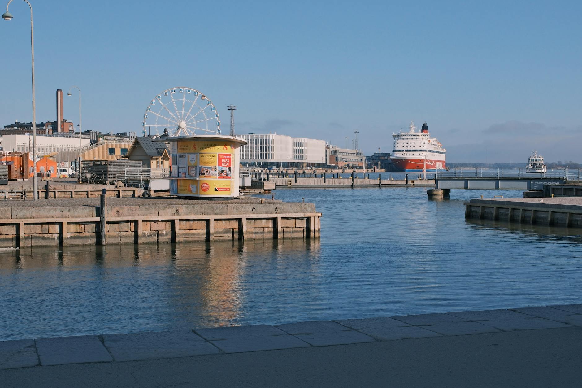 Helsinki harbor with Ferris wheel for tourist weather planning.