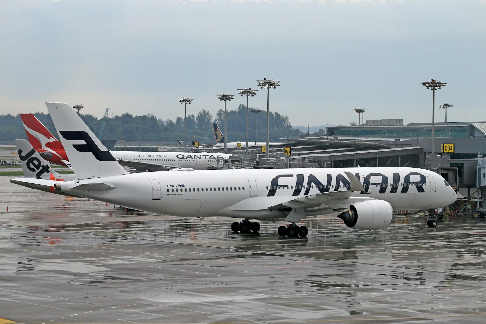 Finnair aircraft at a wet terminal for Helsinki weather planning.