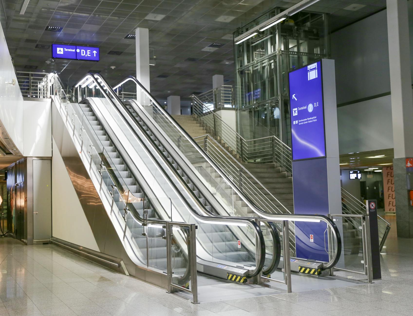 Modern airport terminal escalator for Helsinki luggage planning.