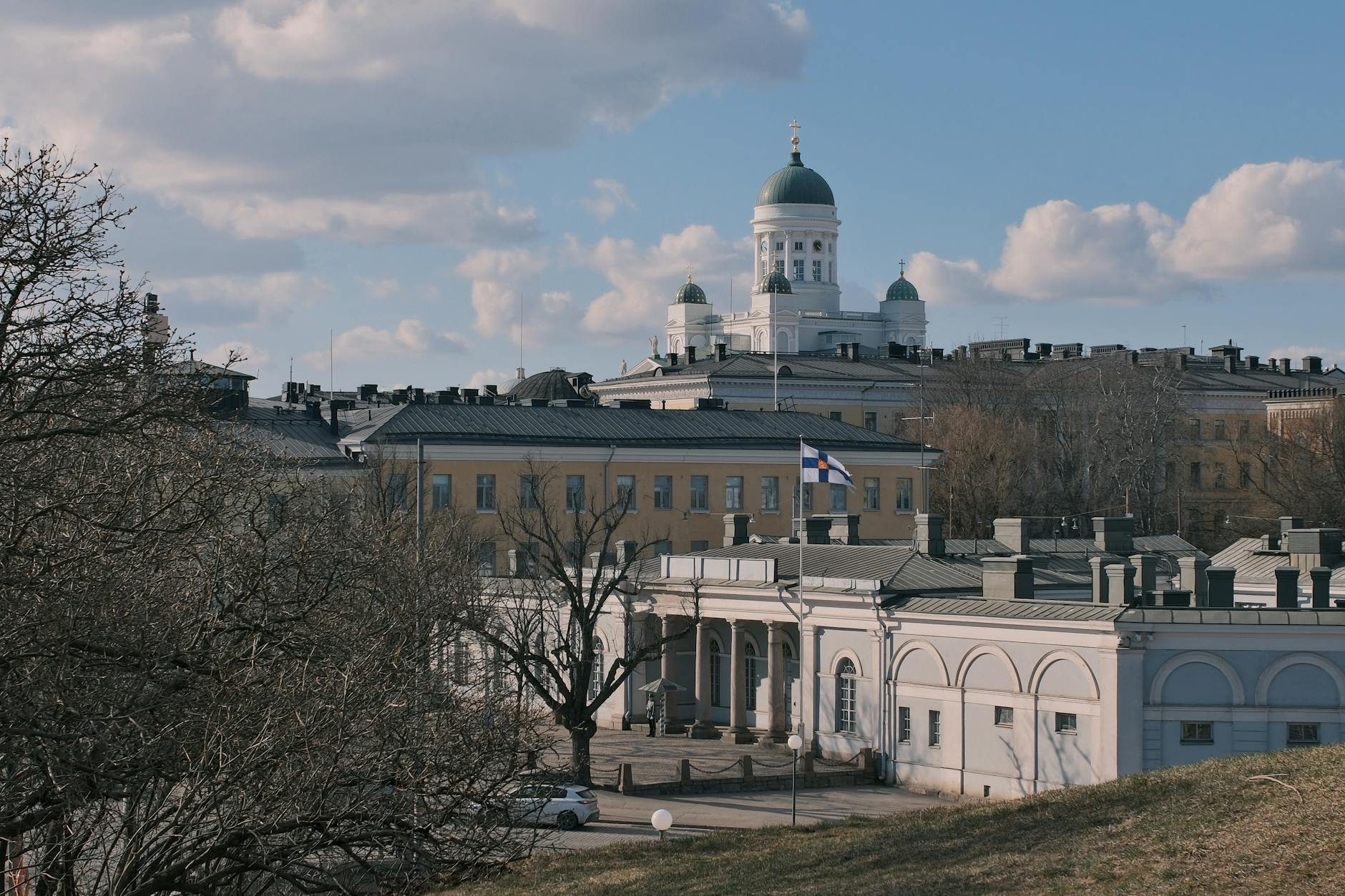Helsinki Cathedral and Finnish flag for medical-constraint travel planning.